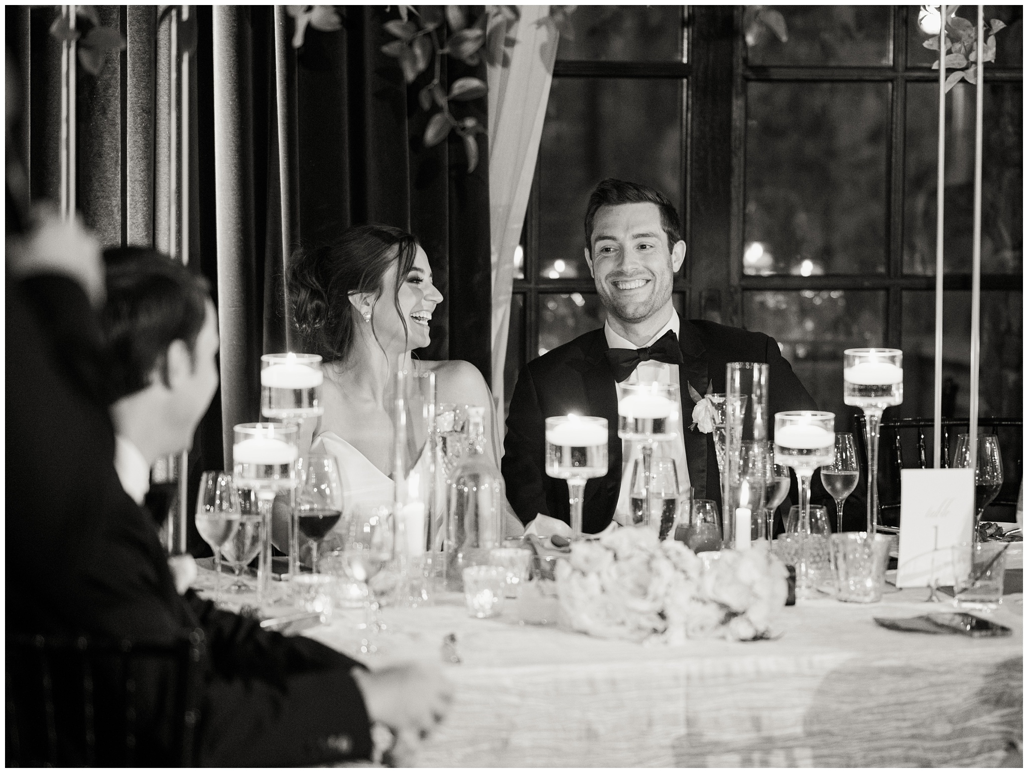 Bride and Groom laughing during reception toasts