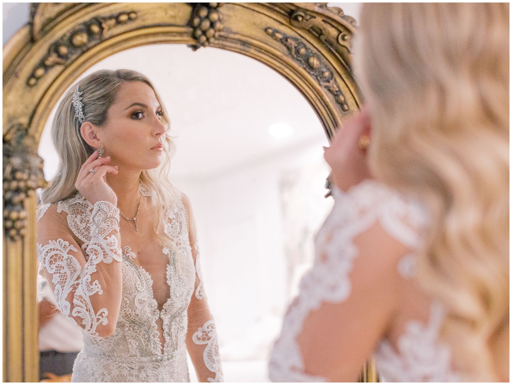 Bride admiring herself in a vintage mirror
