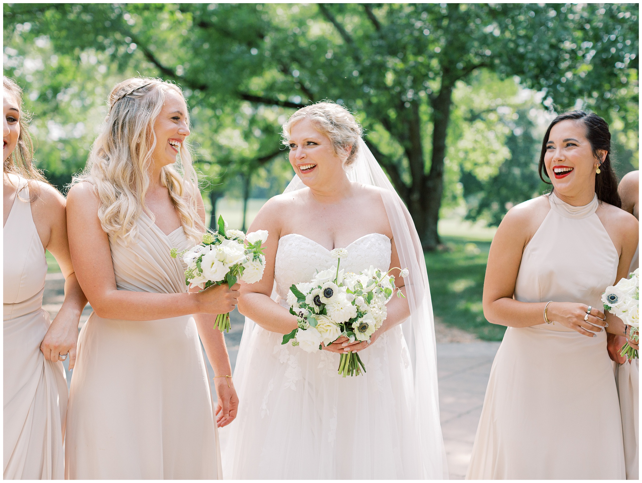 Bride laughing with bridesmaids