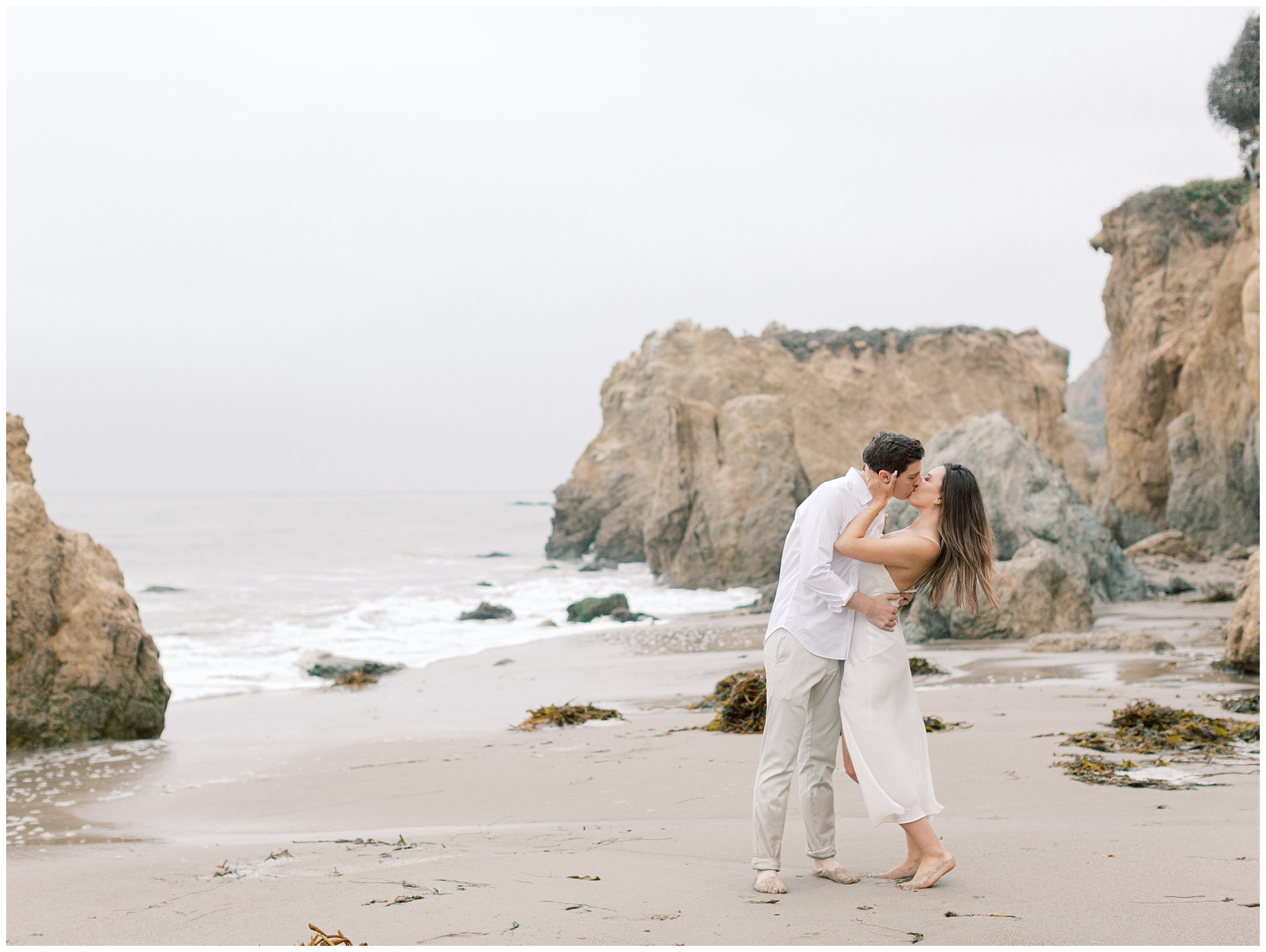 El Matador Beach engagement photo on overcast day