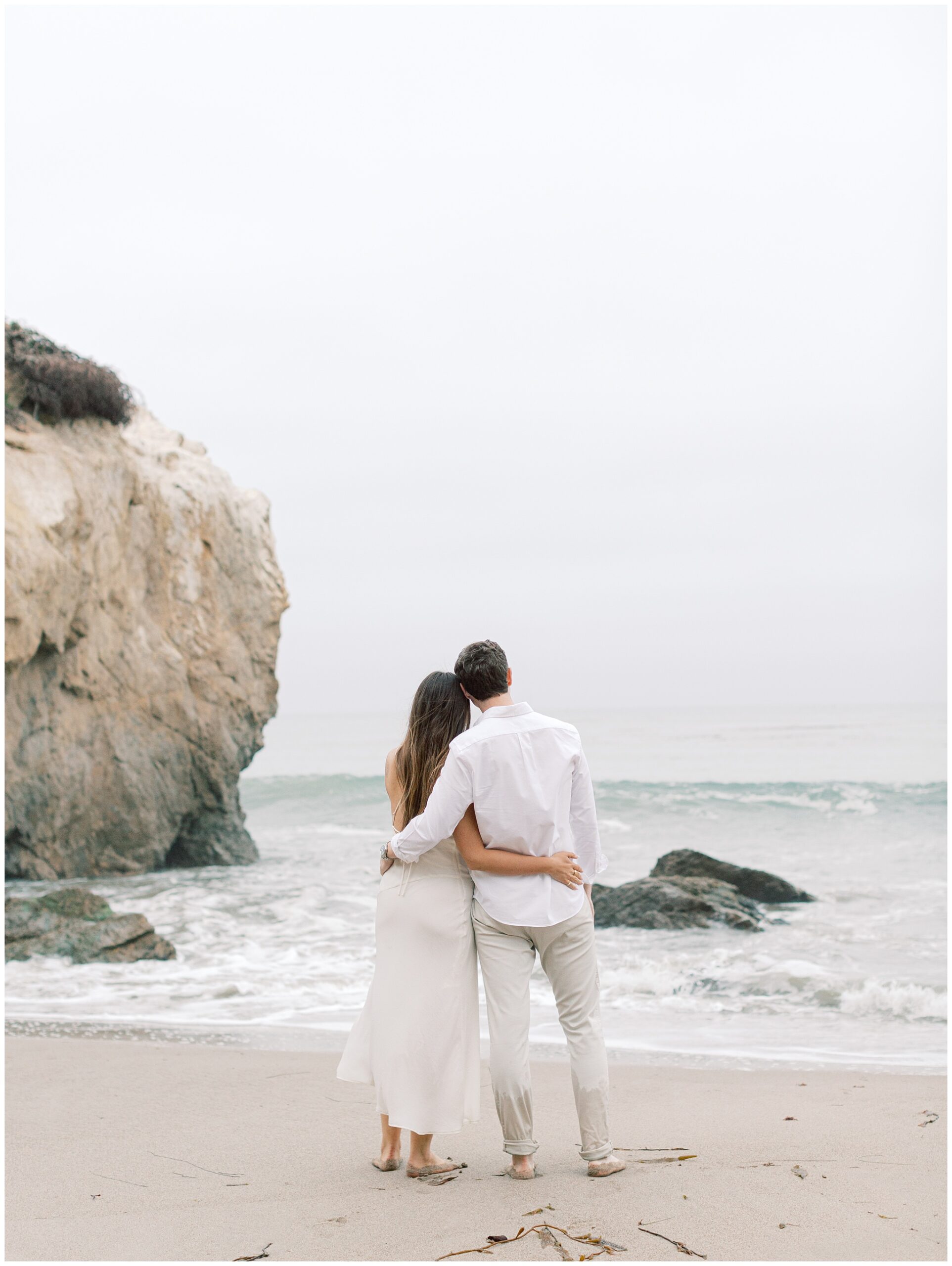 El Matador Beach engagement photo on overcast day