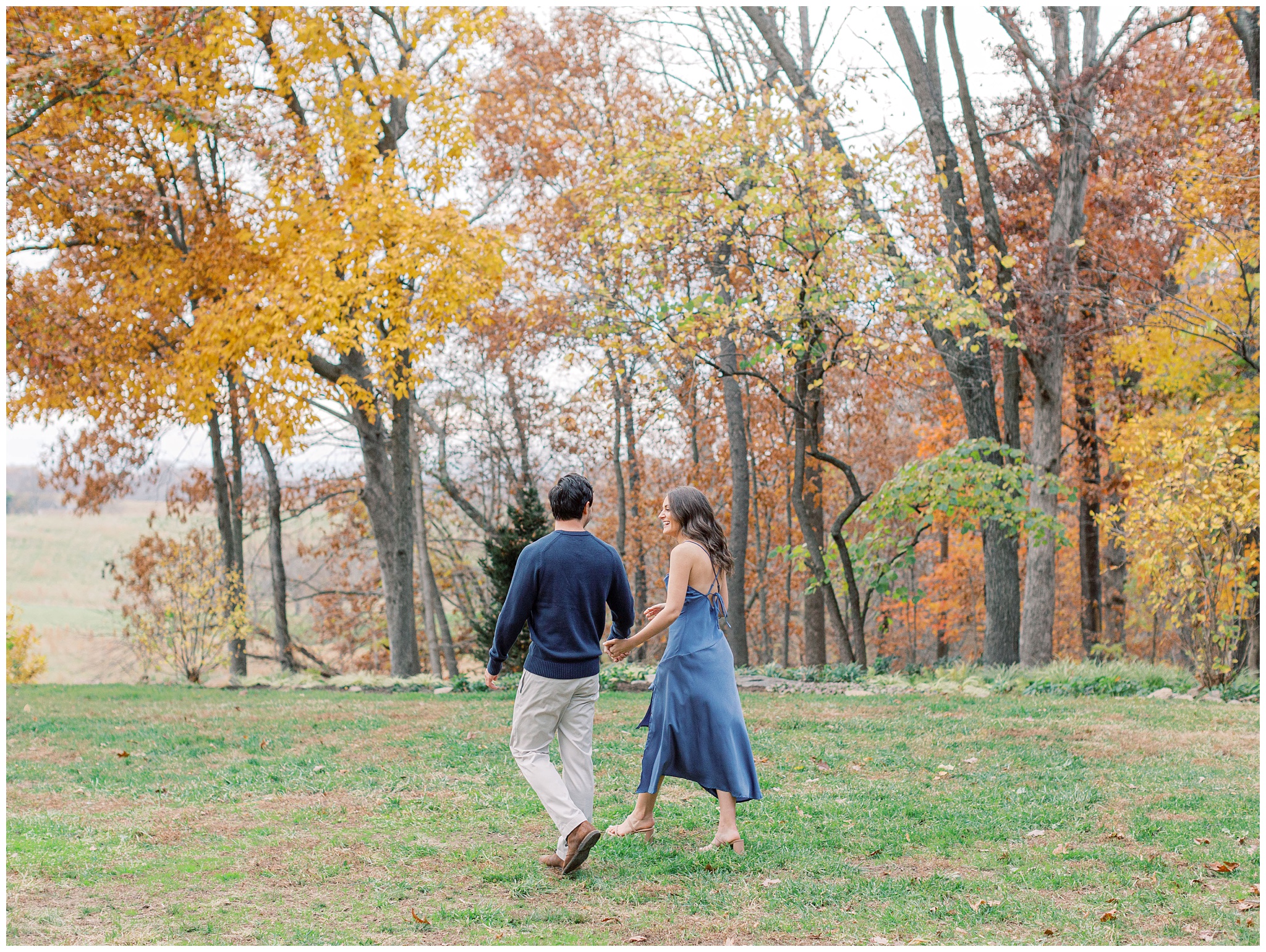 Goodstone Inn engagement photo couple walking with fall foliage