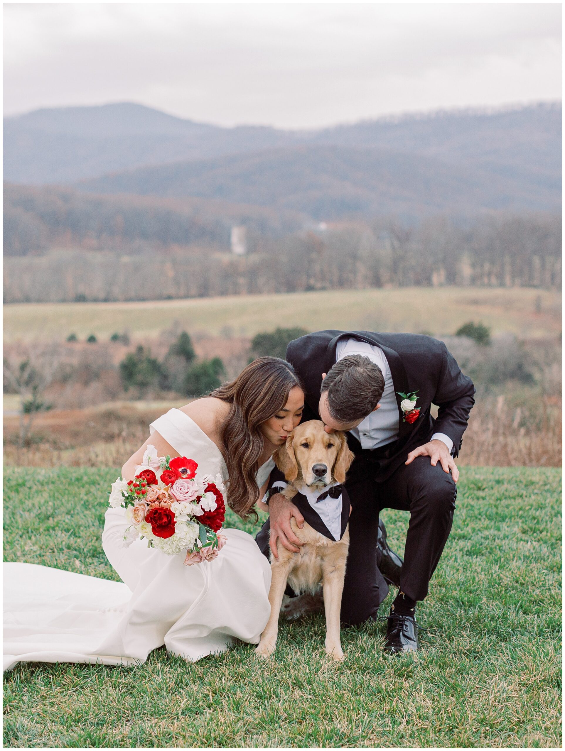 Bride and Groom kissing their best pup