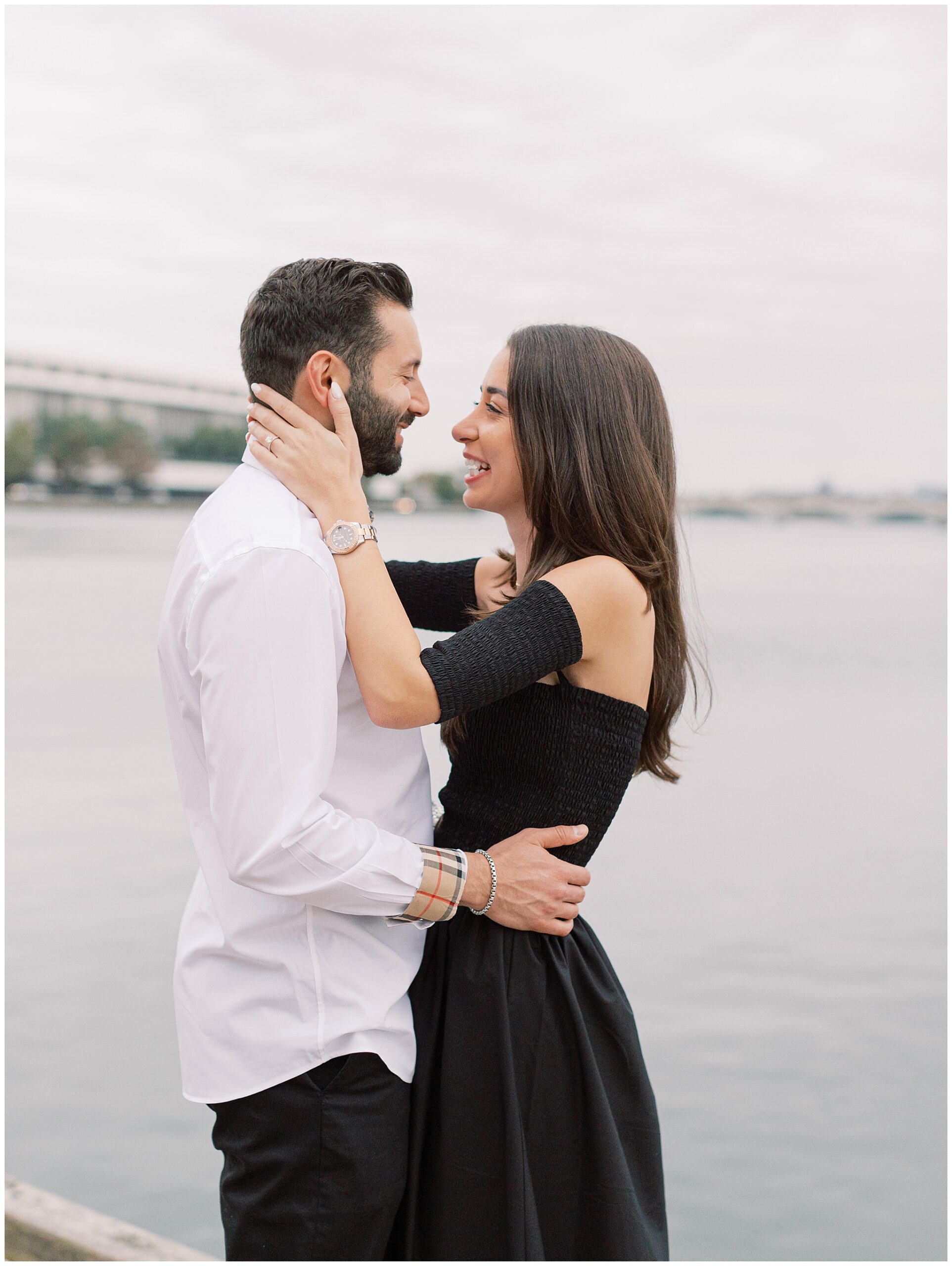 Newly engaged couple in front of the Kennedy Center at the Georgetown waterfront in Washington DC