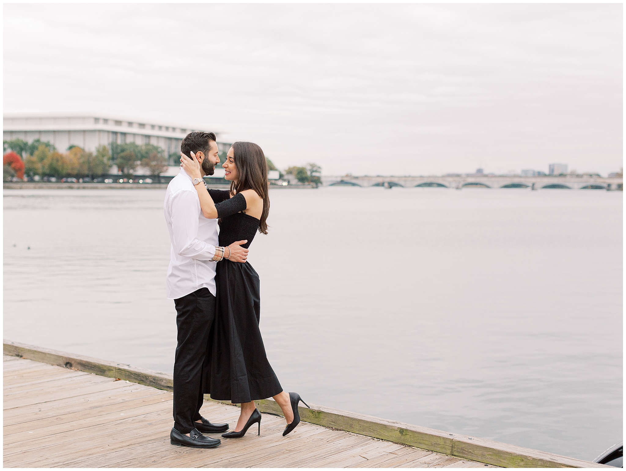 Newly engaged couple in front of the Kennedy Center at the Georgetown waterfront in Washington DC