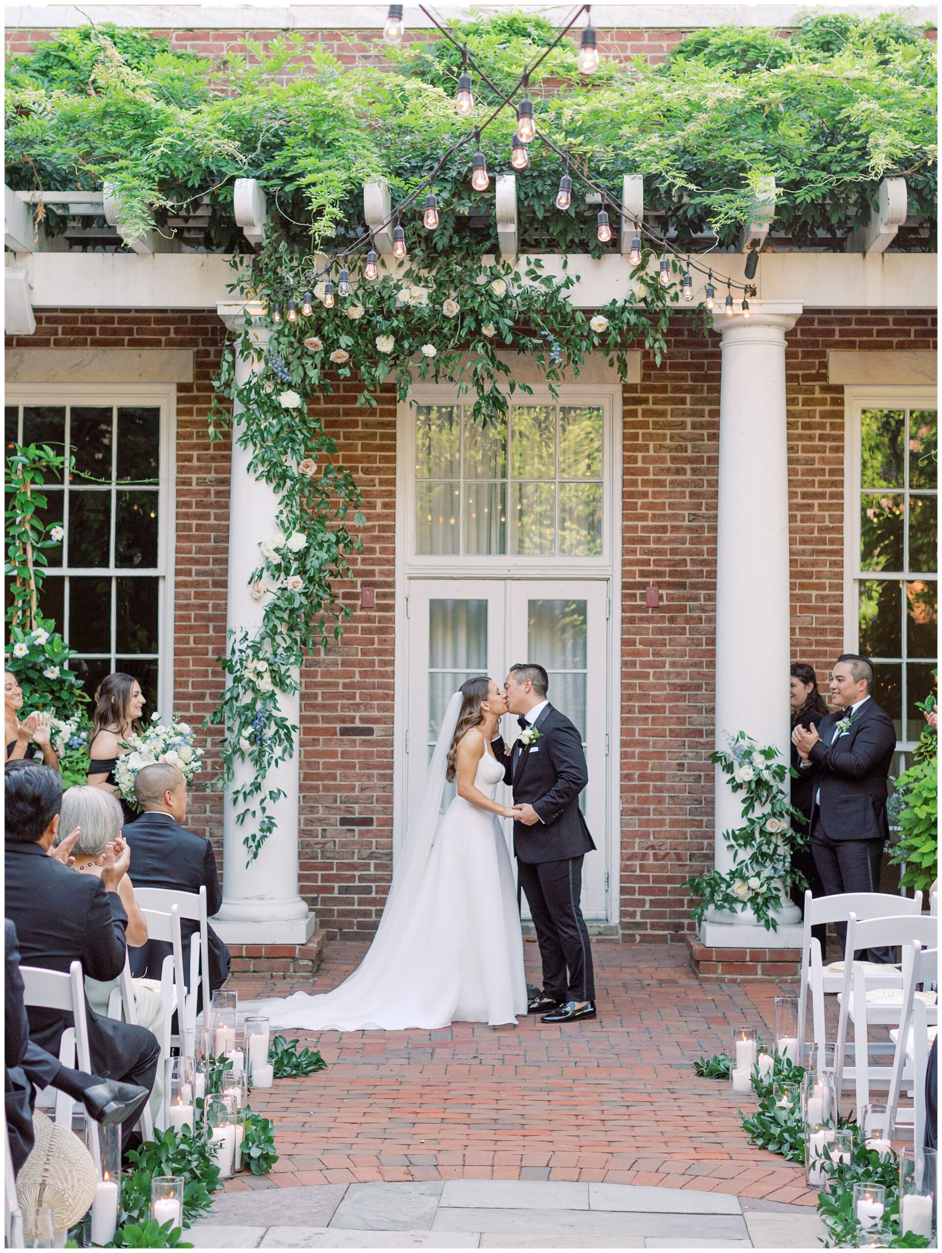 Bride and groom kissing at the wedding ceremony at the Tidewater Inn in Easton, Maryland