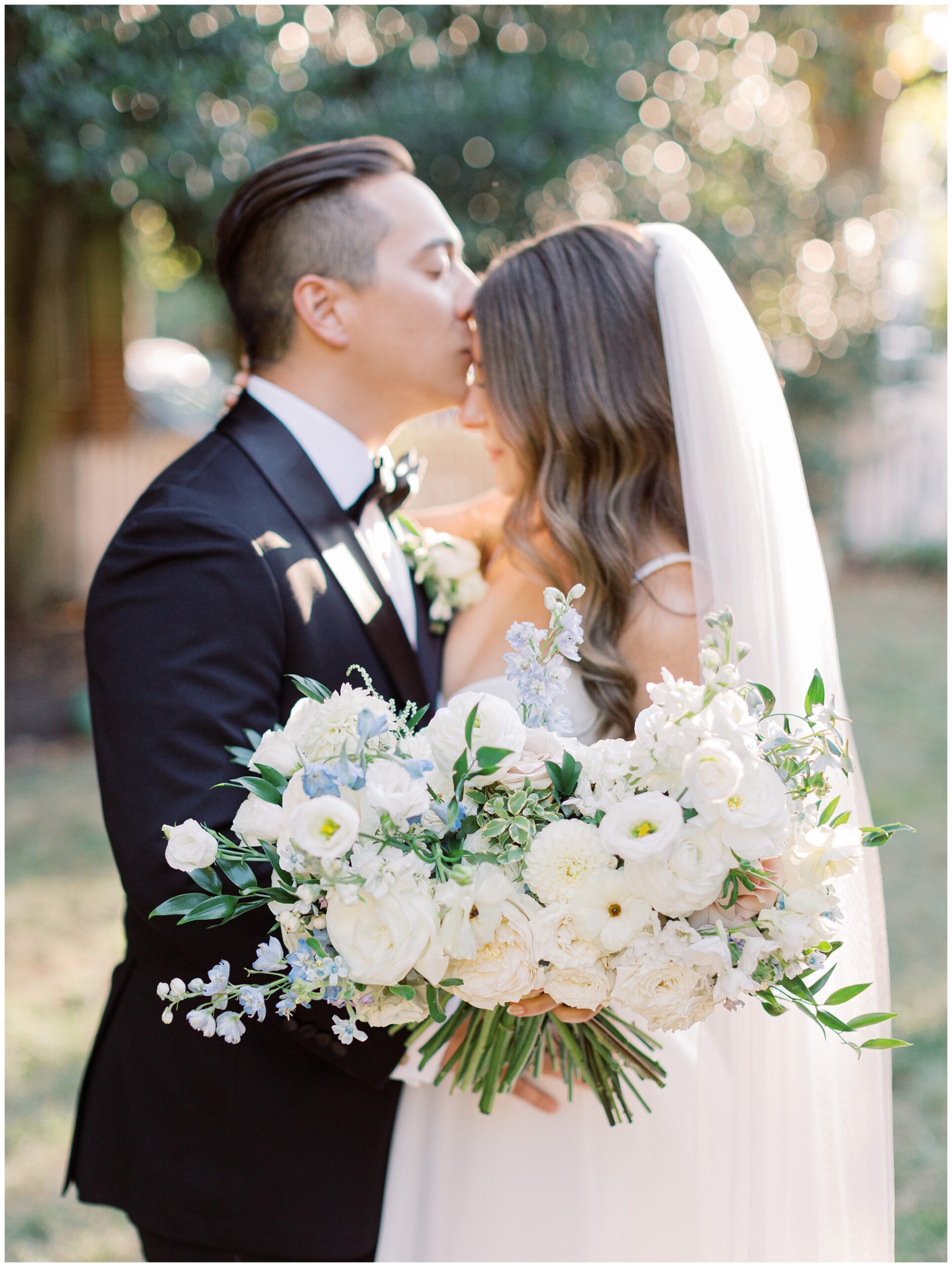 Tidewater Inn wedding newlywed portrait of groom kissing the bride's forehead