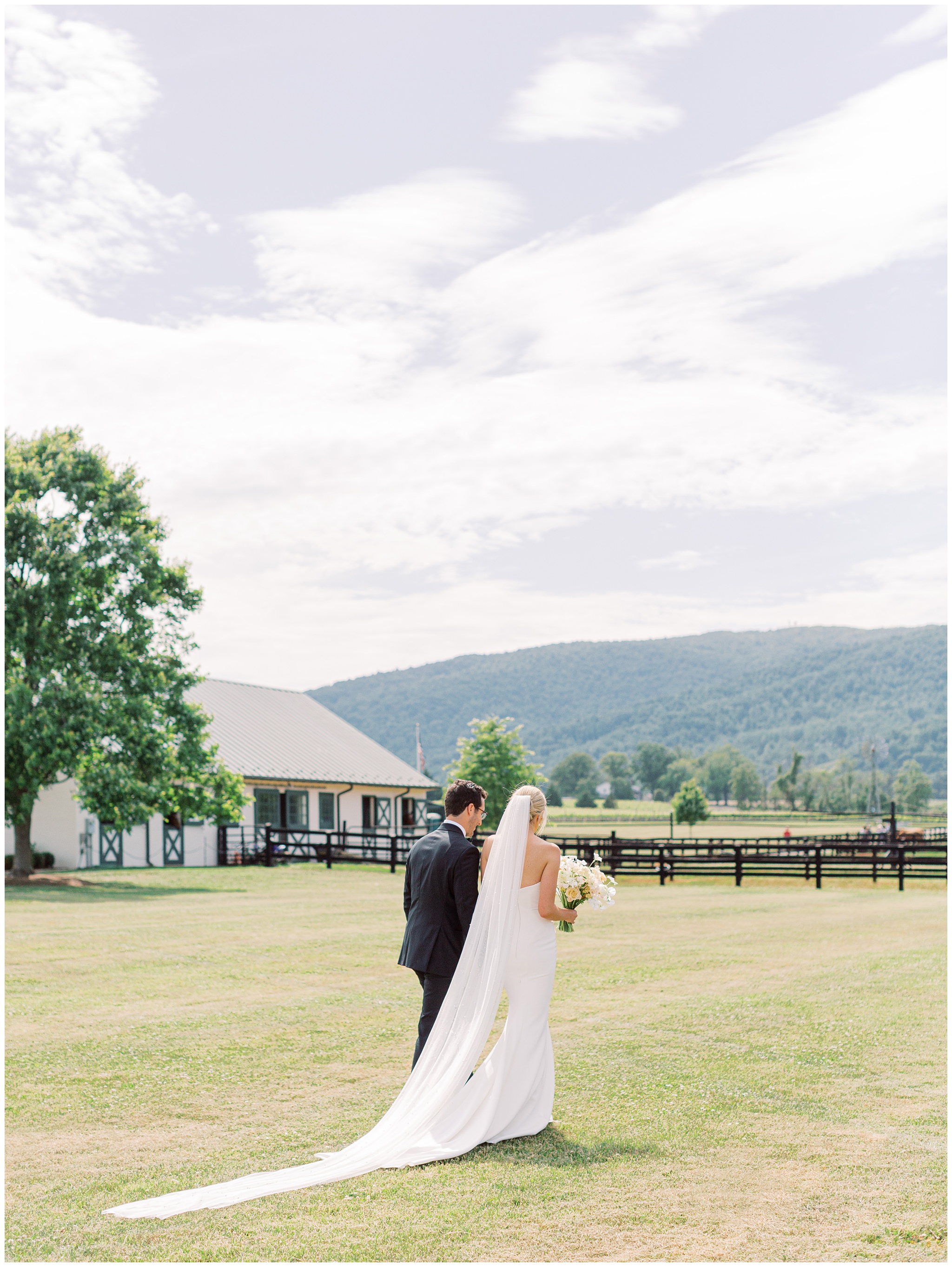 King Family Vineyards wedding bride and groom walking towards mountains