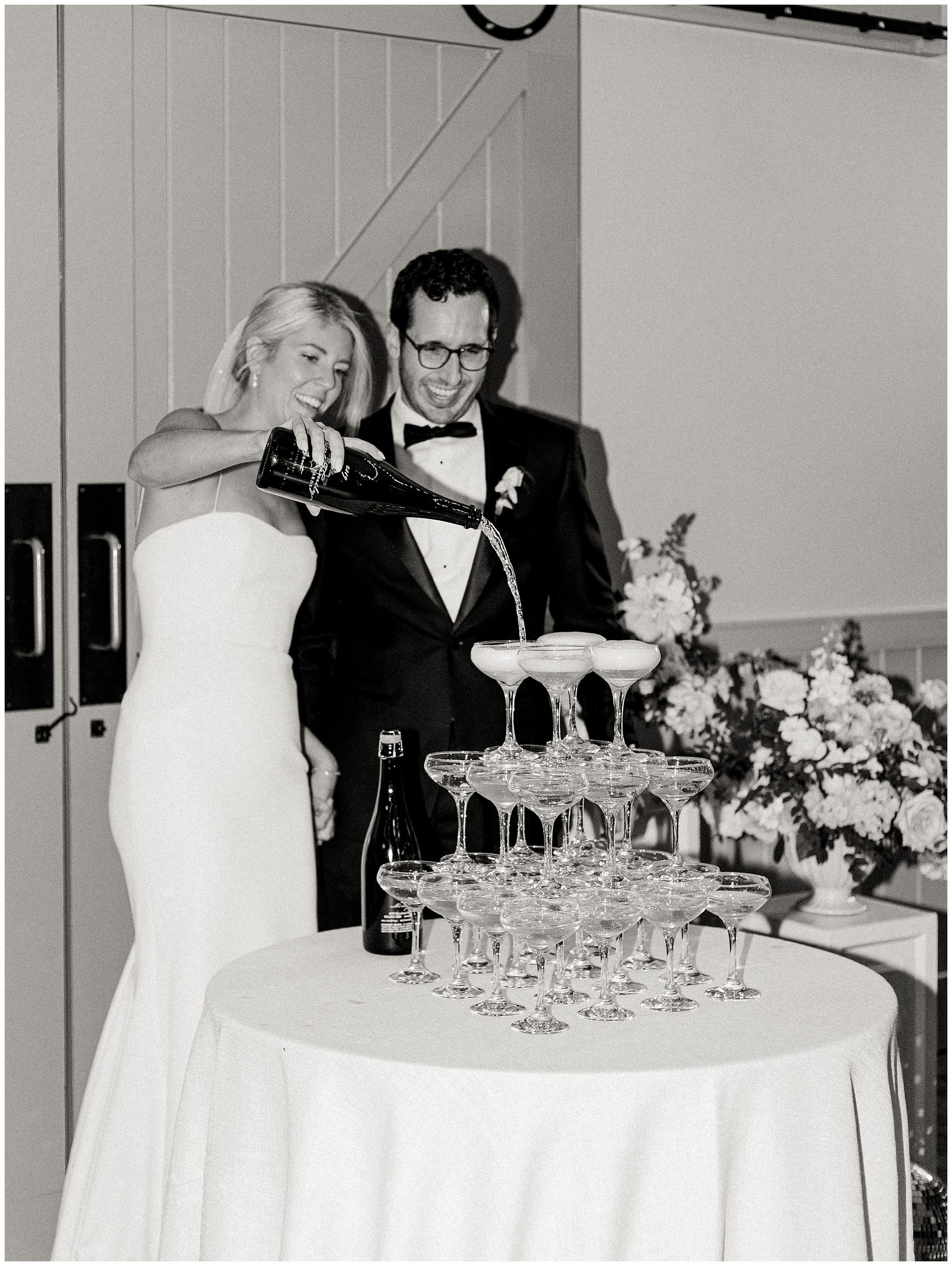 Bride and Groom pouring champagne at King Family Vineyards reception
