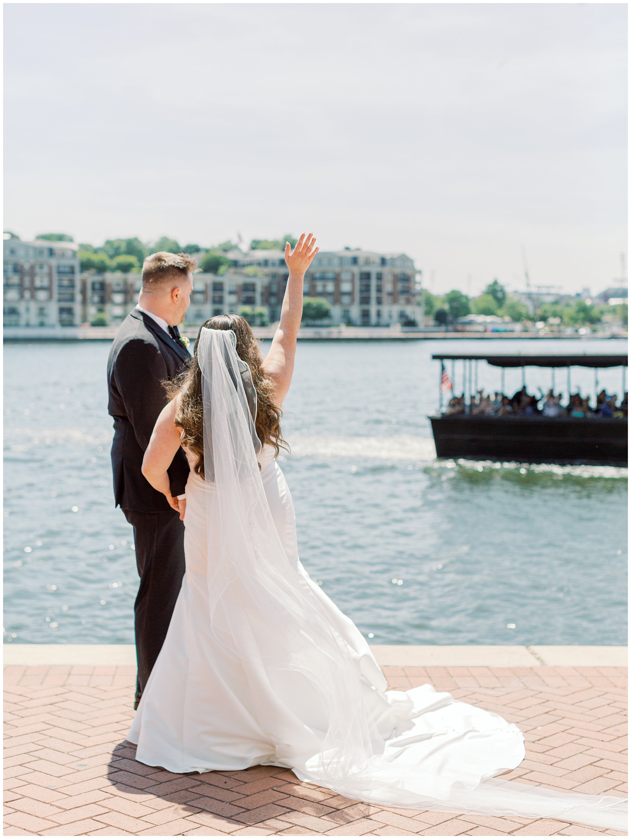 Bride and Groom waving at Baltimore waterfront