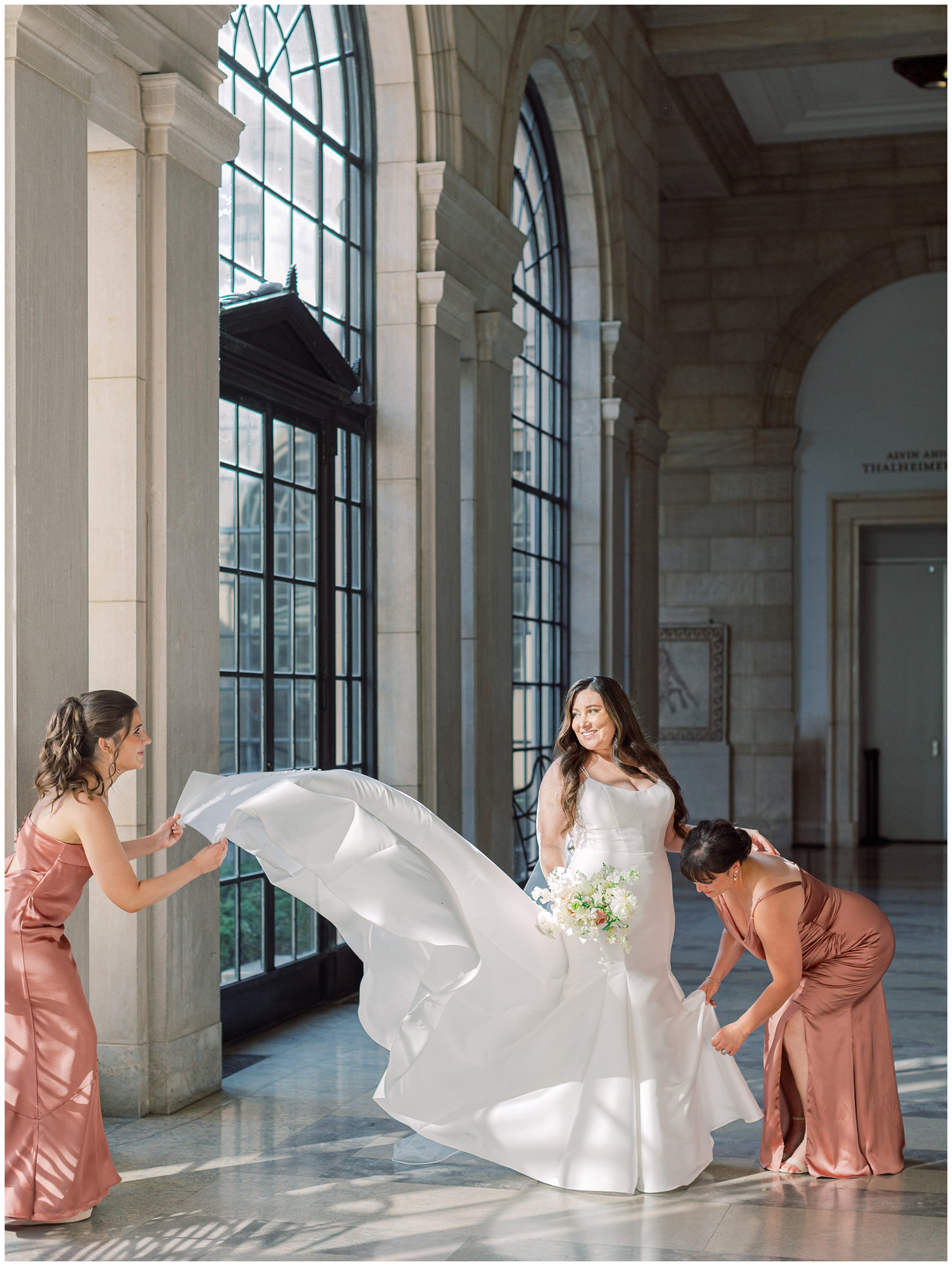 Bridesmaids fluffing Bride's dress at the Baltimore Museum of Art
