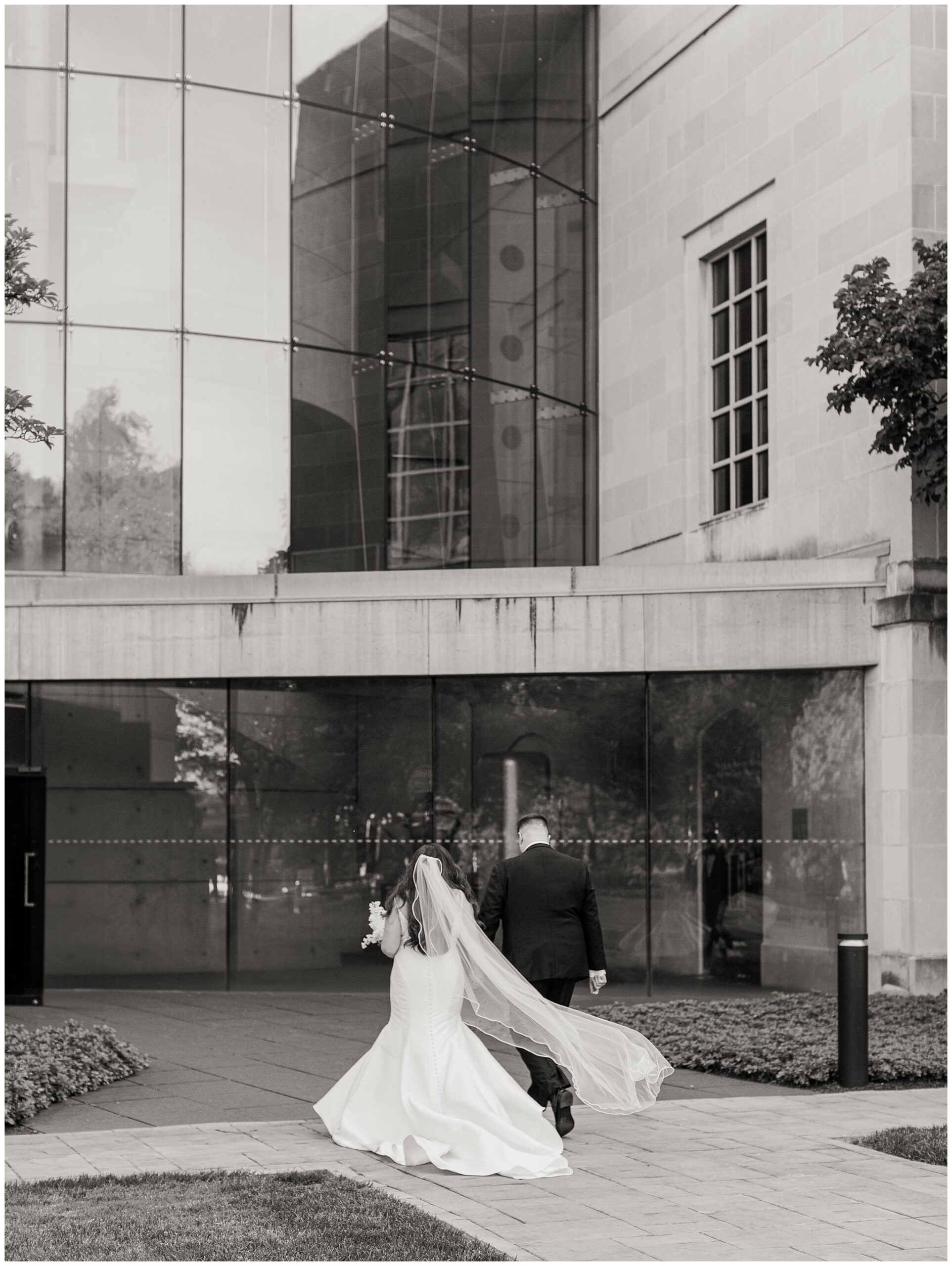 Black and white photo of Bride and Groom walking away