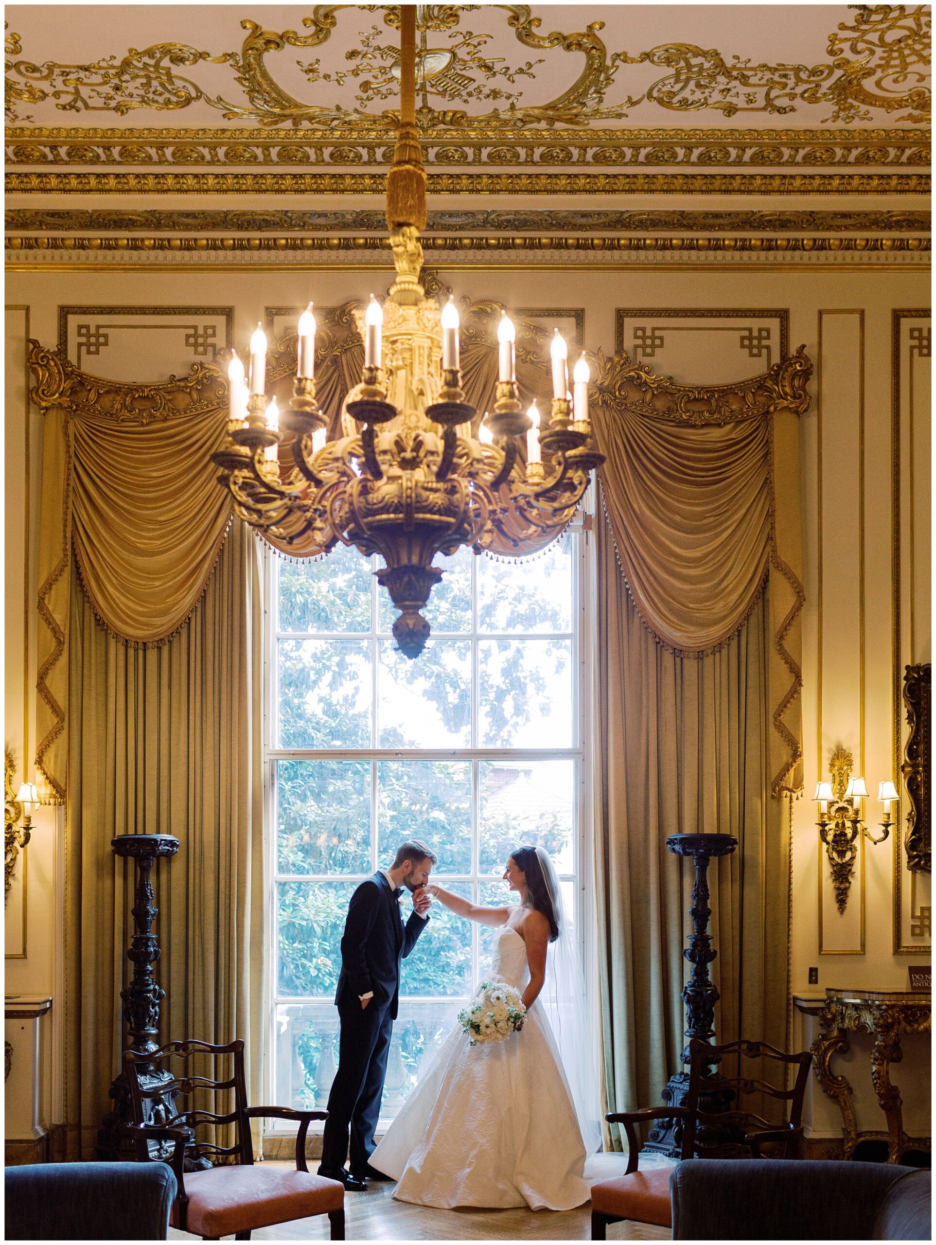 Anderson House wedding photo of groom kissing bride's hand
