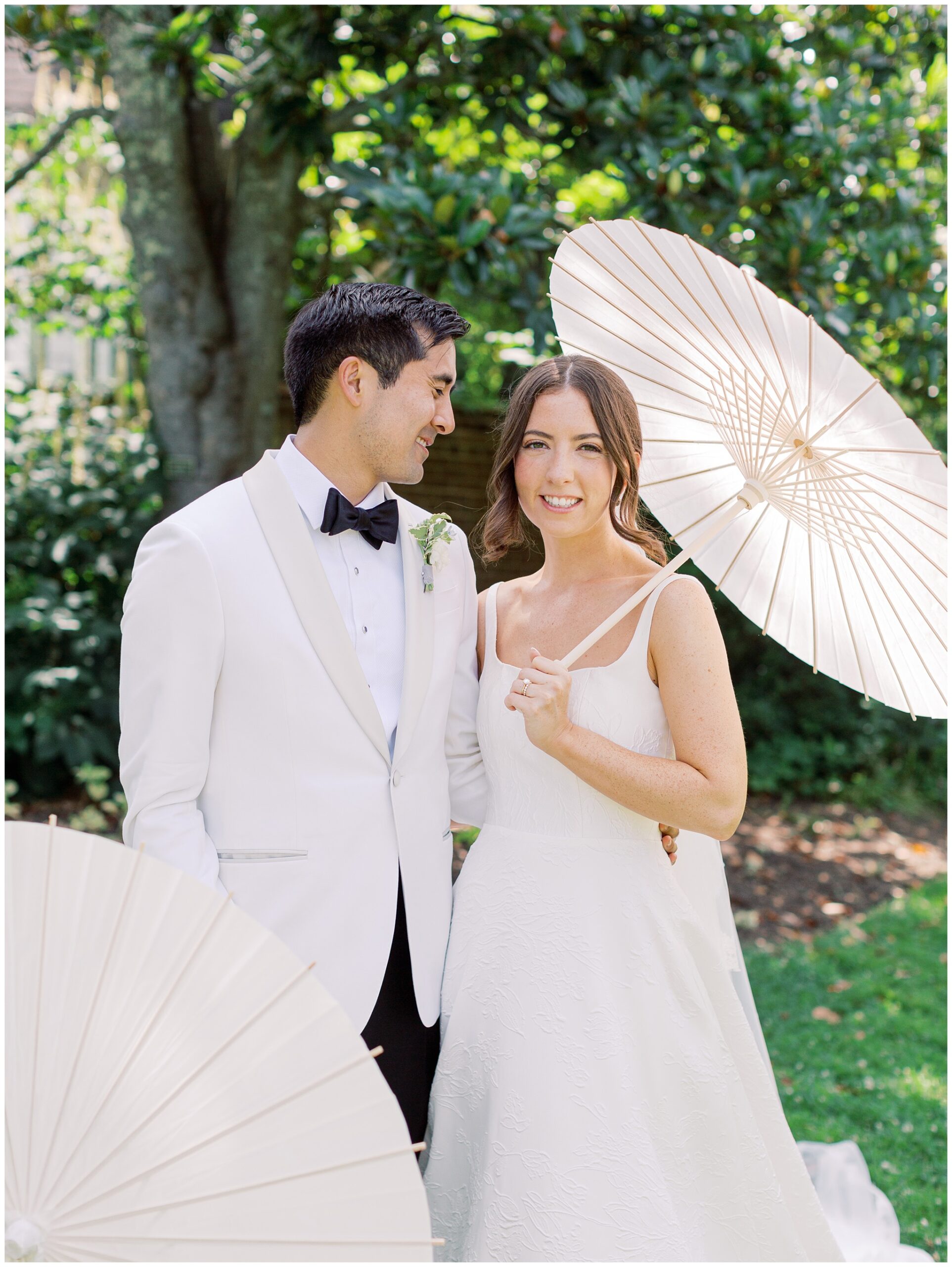 River Run wedding photo of bride and groom with parasols