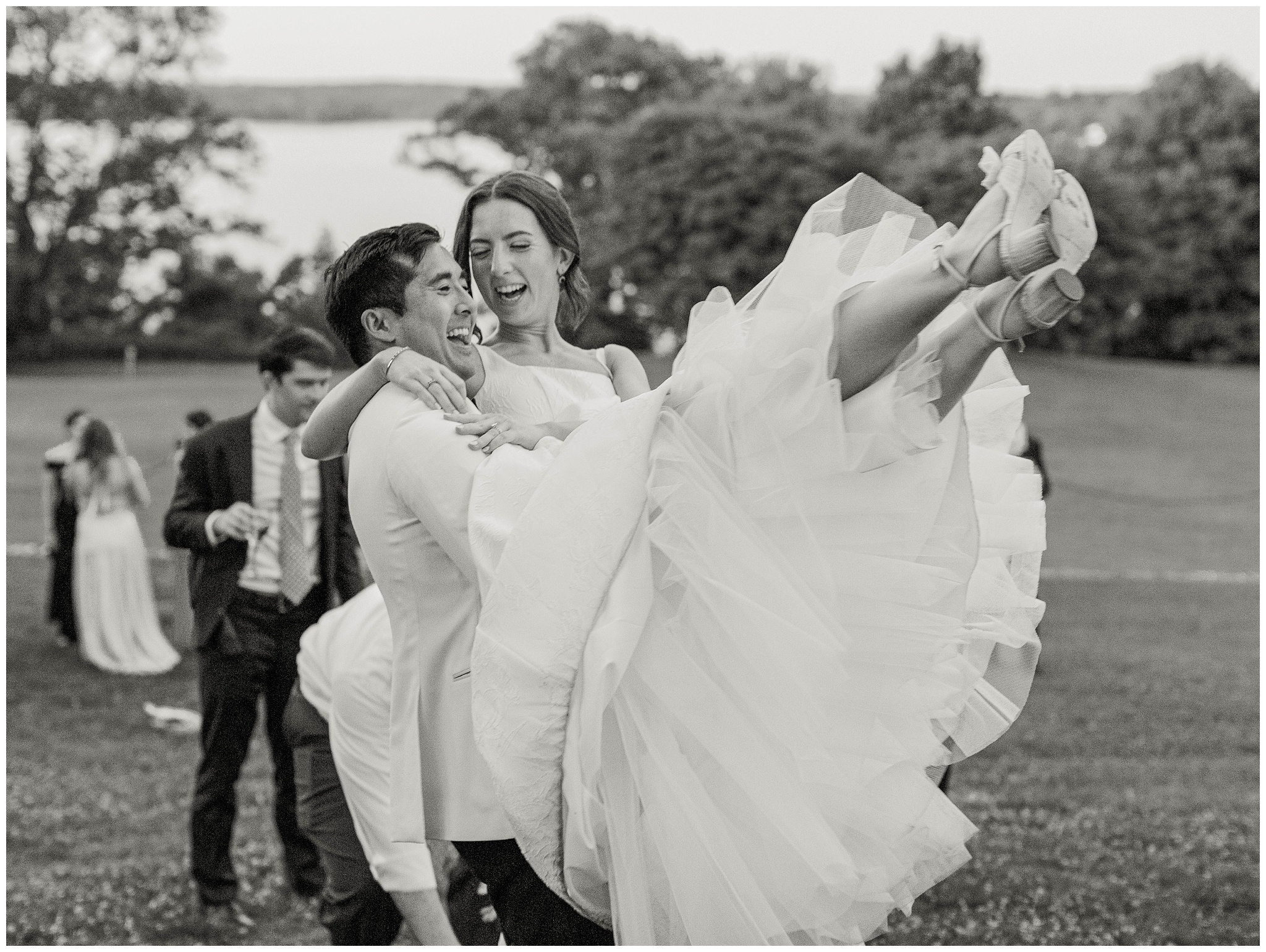 River Farm wedding photo of groom carrying bride