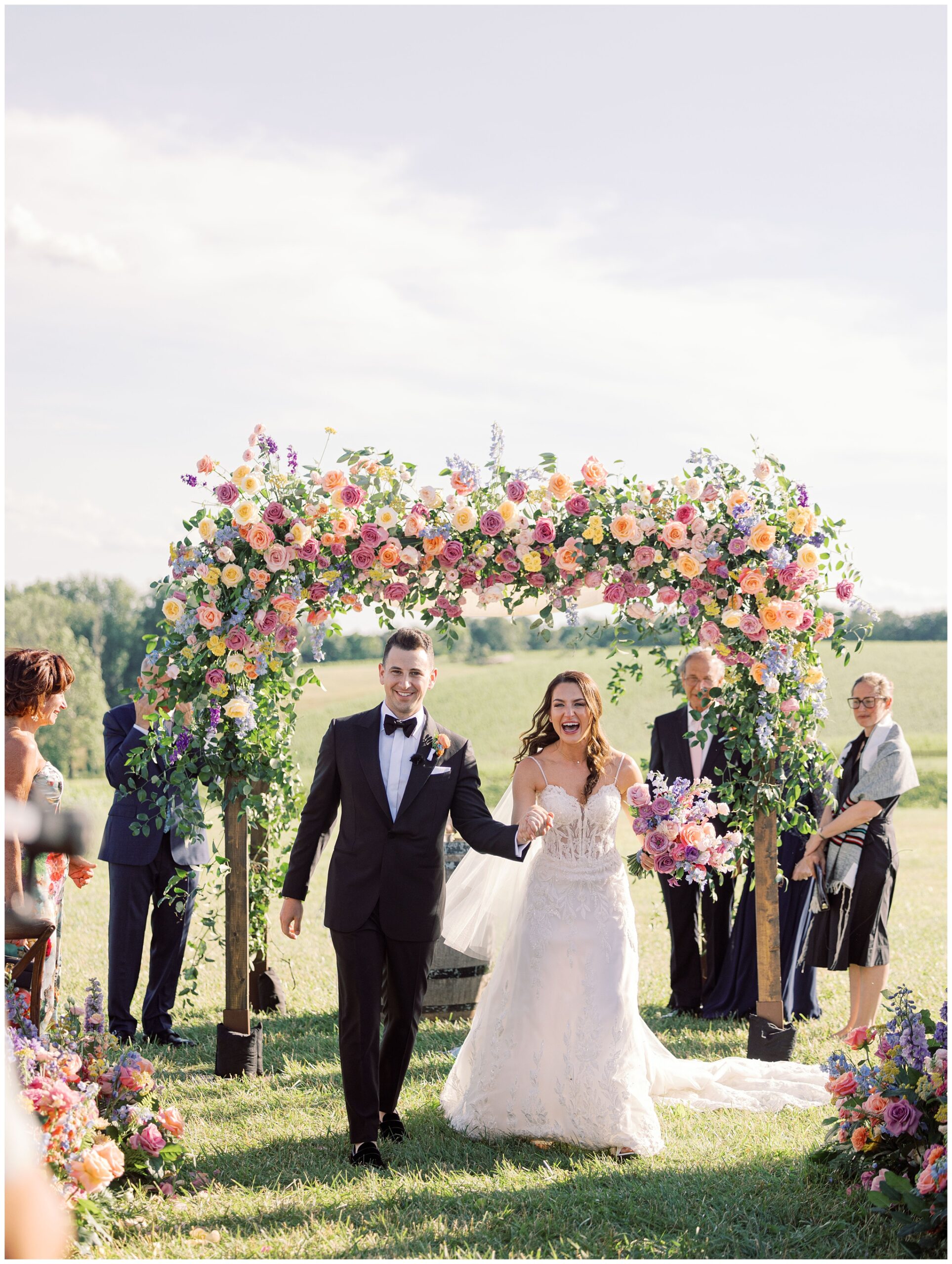 bride and groom happily walking down the aisle during Stone Tower Winery wedding ceremony