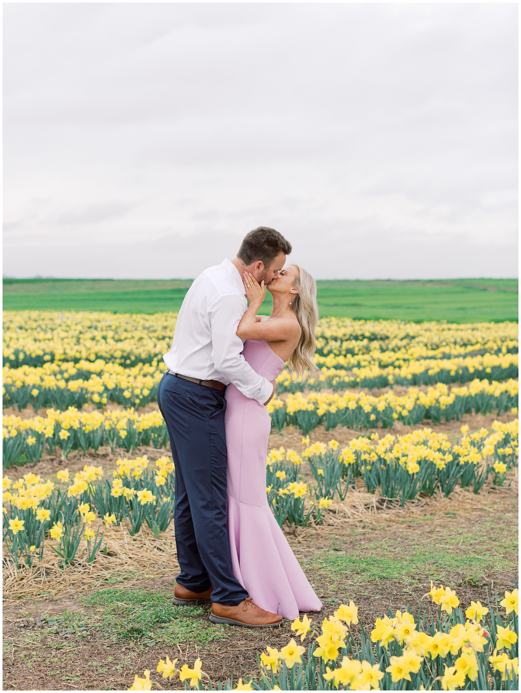 Couple kissing in daffodil fields at Burnside Farms