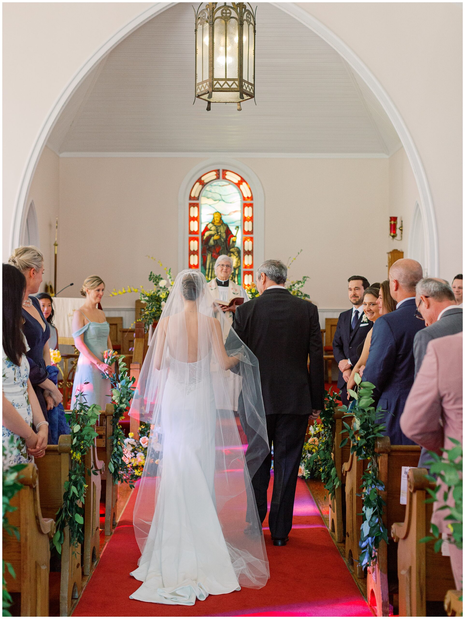 Bride and her dad walking down the aisle from behind