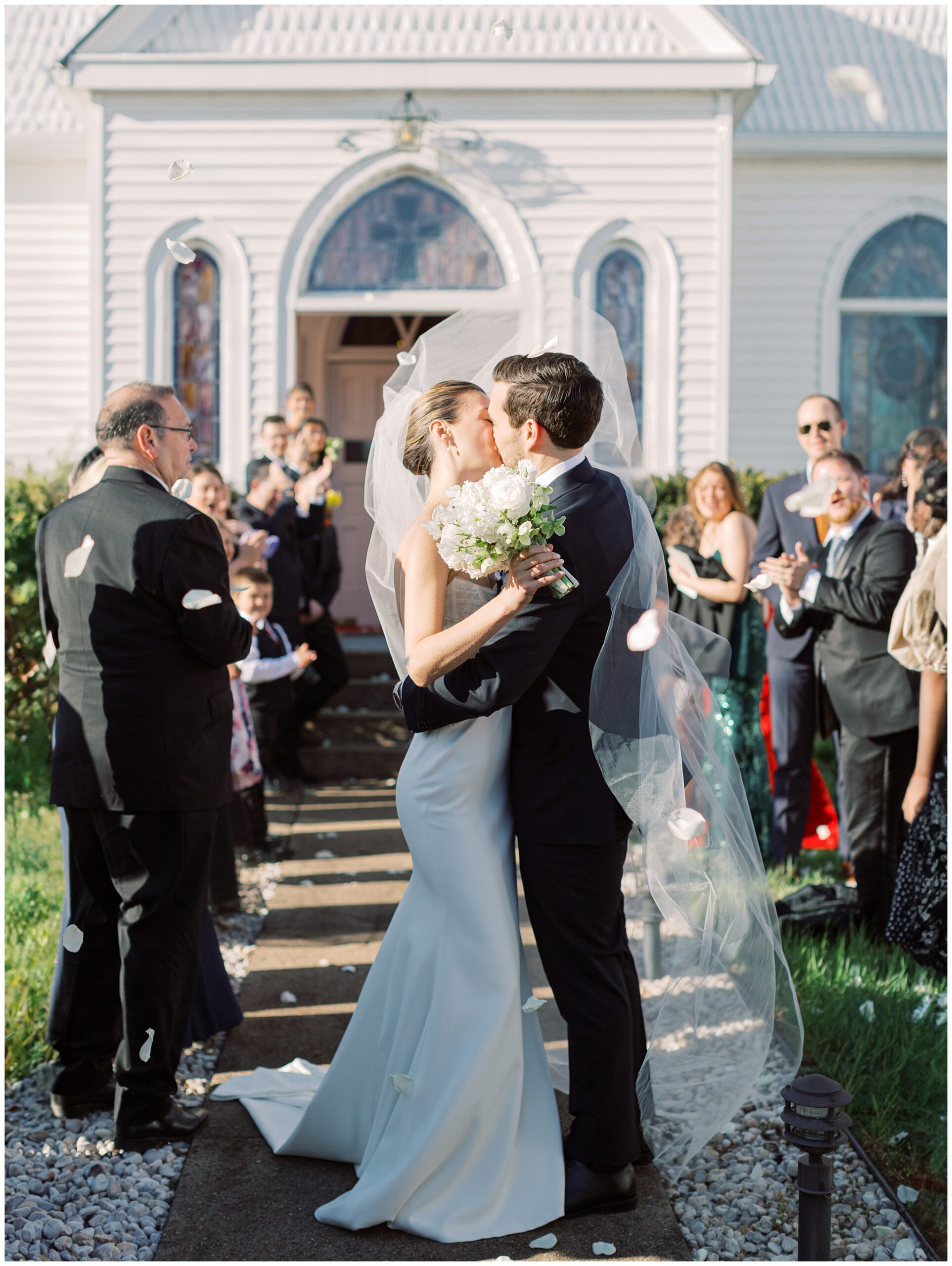Bride and Groom kiss outside the church