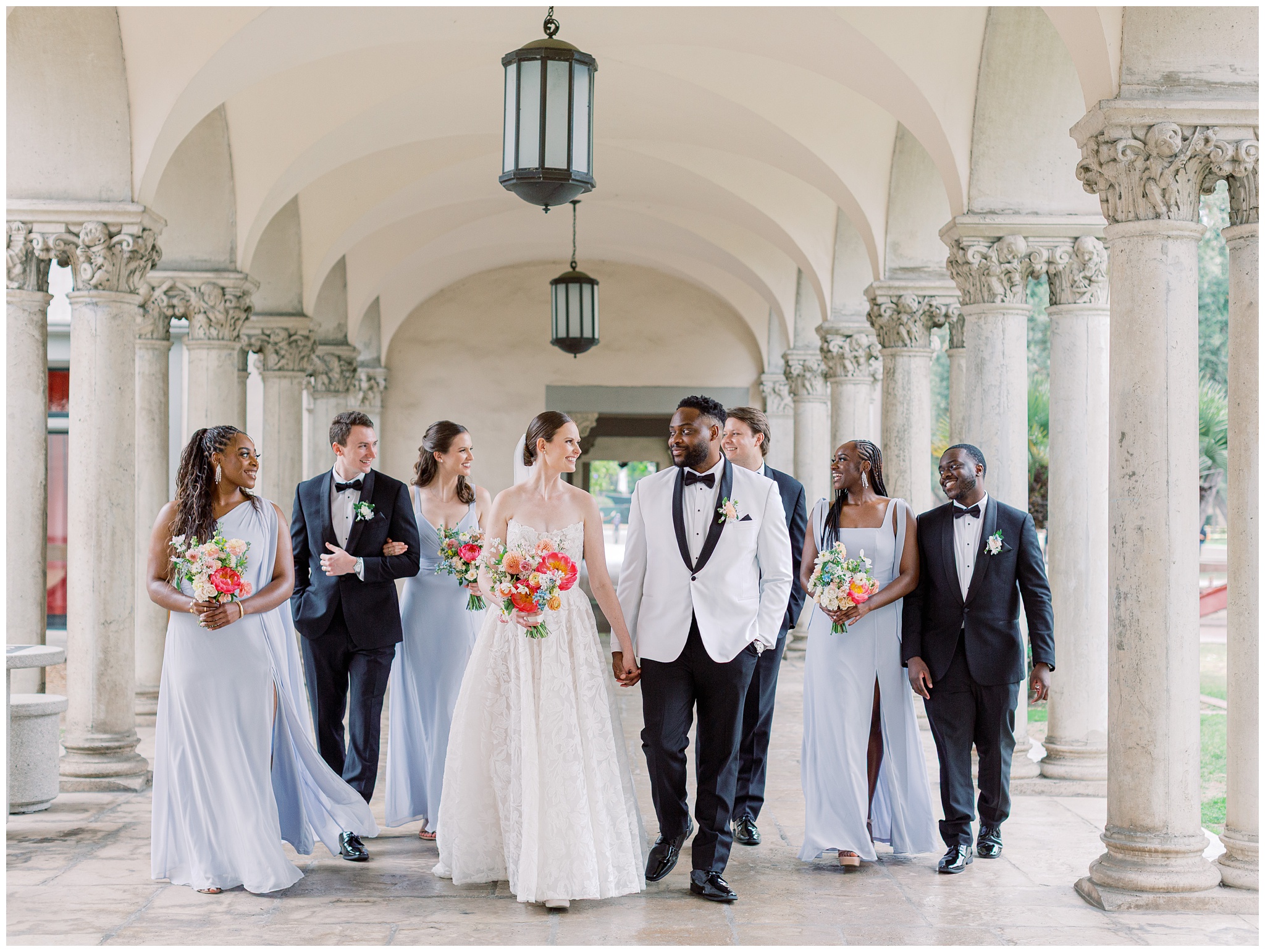 Wedding party walking under columns at Caltech Athenaeum wedding
