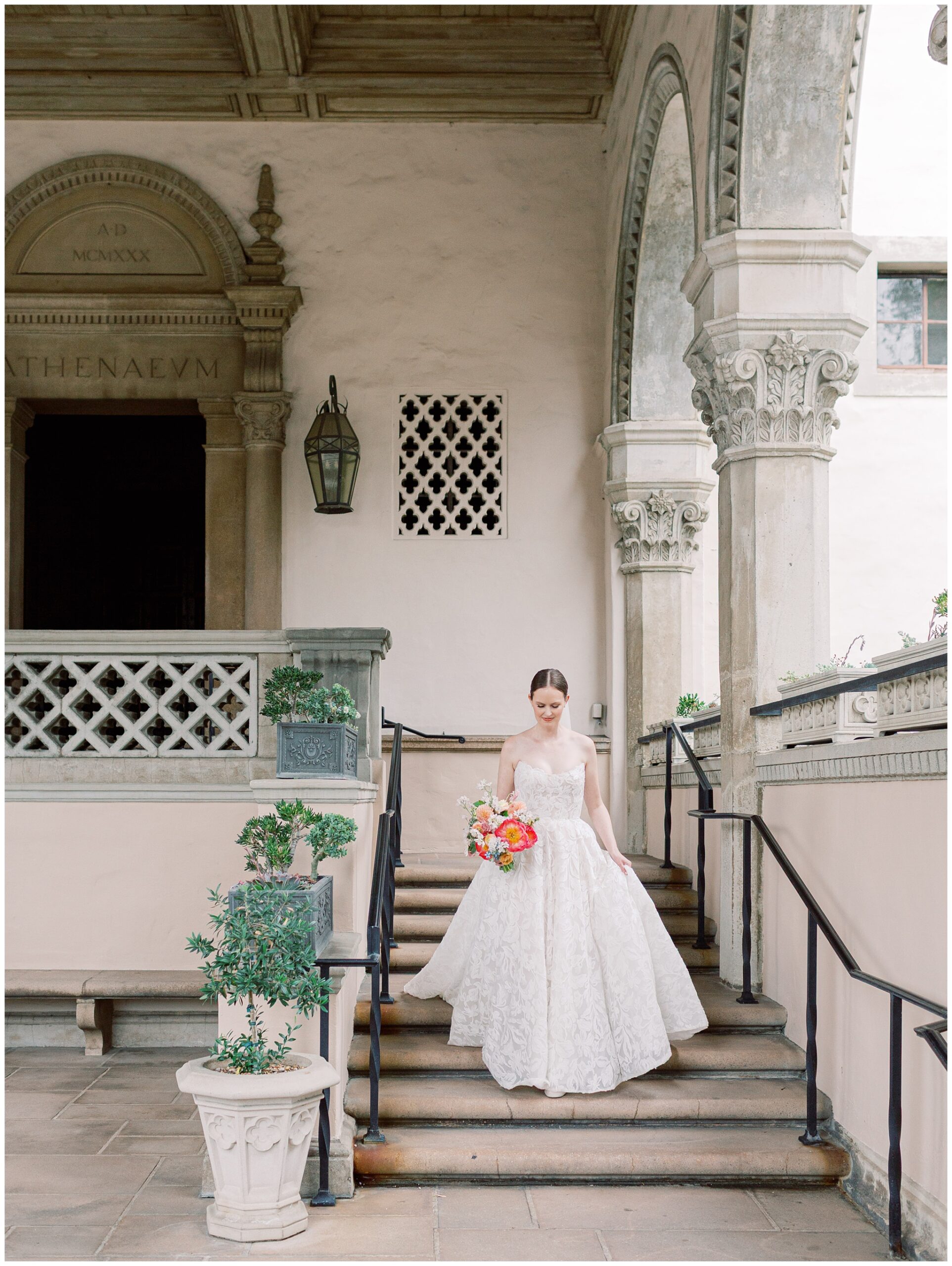 Bride walking down steps at Caltech Athenaeum wedding