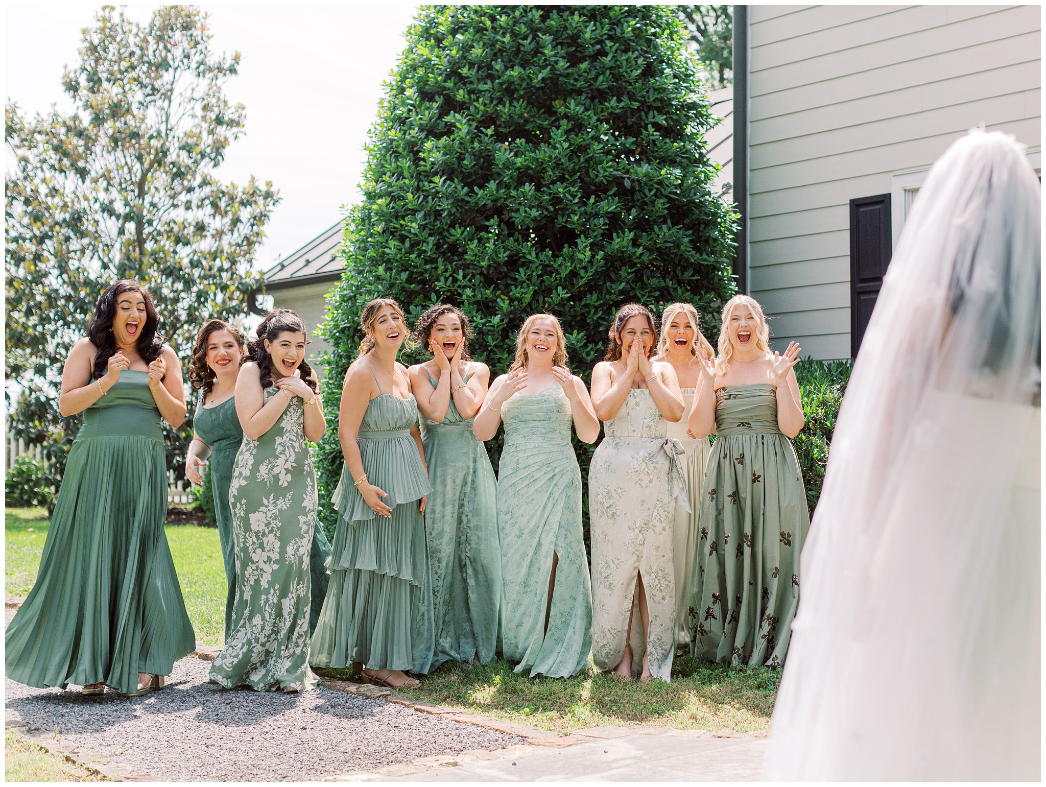 First look with bridesmaids outside Farmhouse
