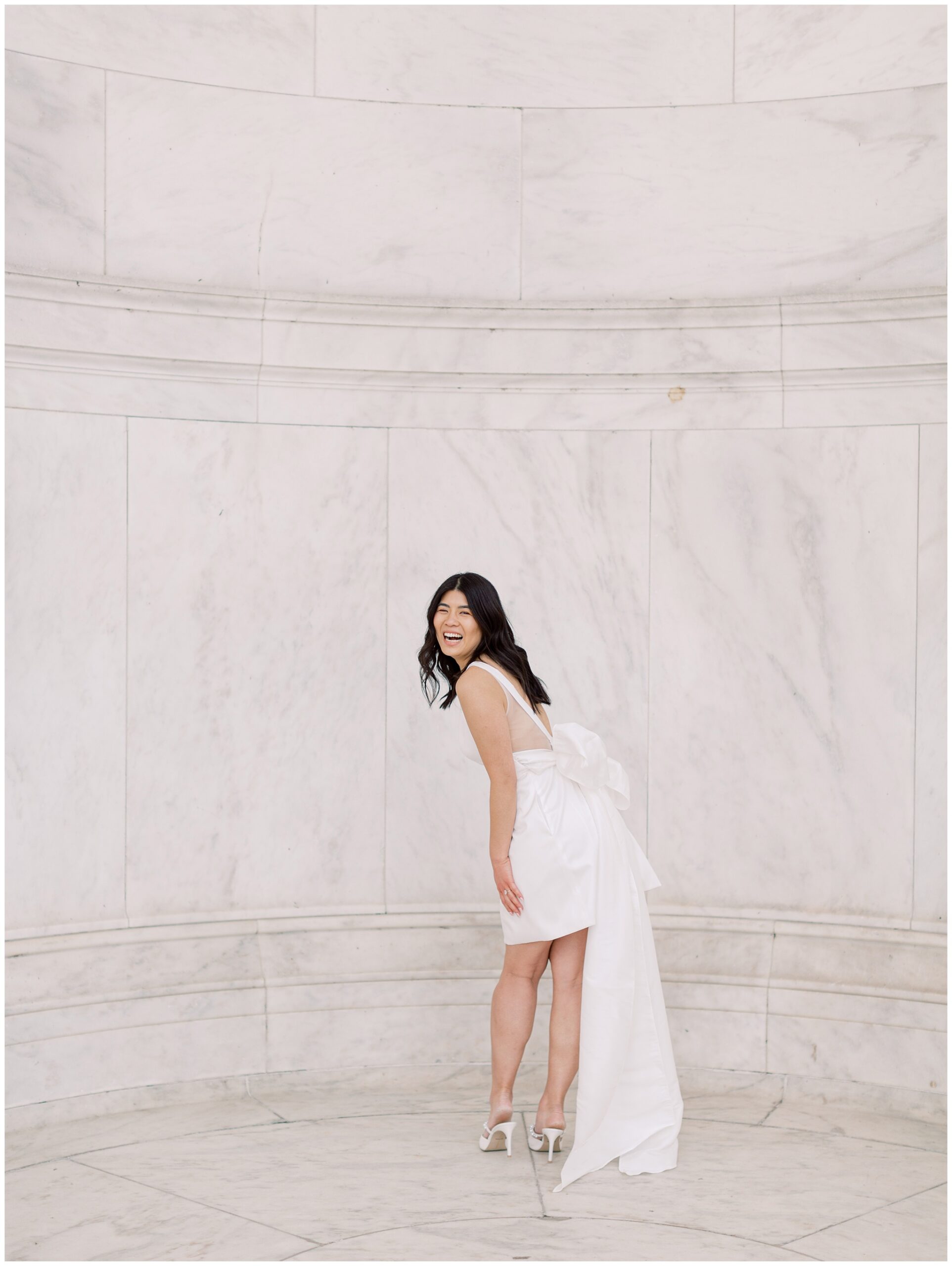 Bride laughing wearing Jenny Yoo gown with large bow