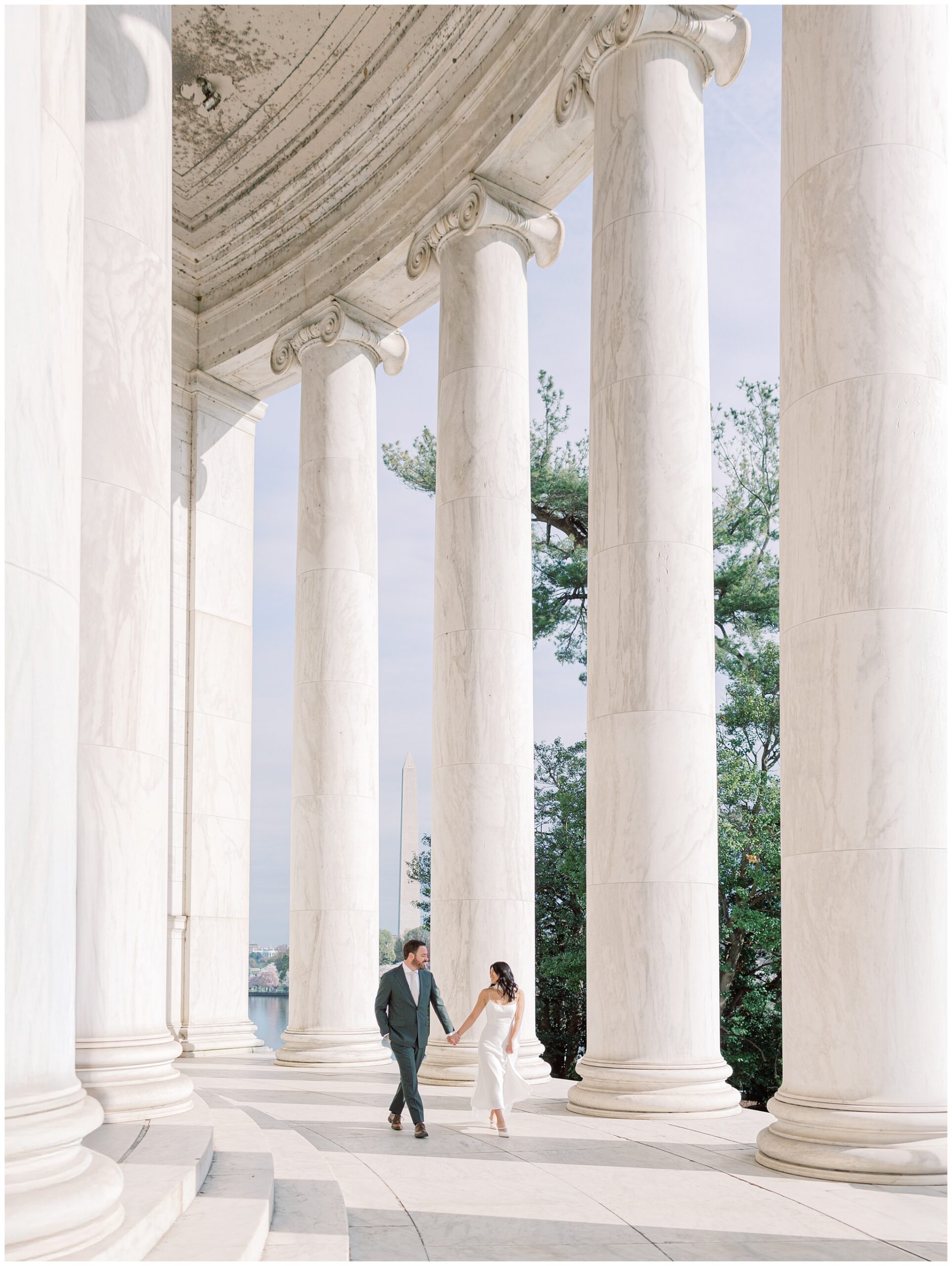 Romantic engagement portraits at the Jefferson Memorial during cherry blossom peak bloom
