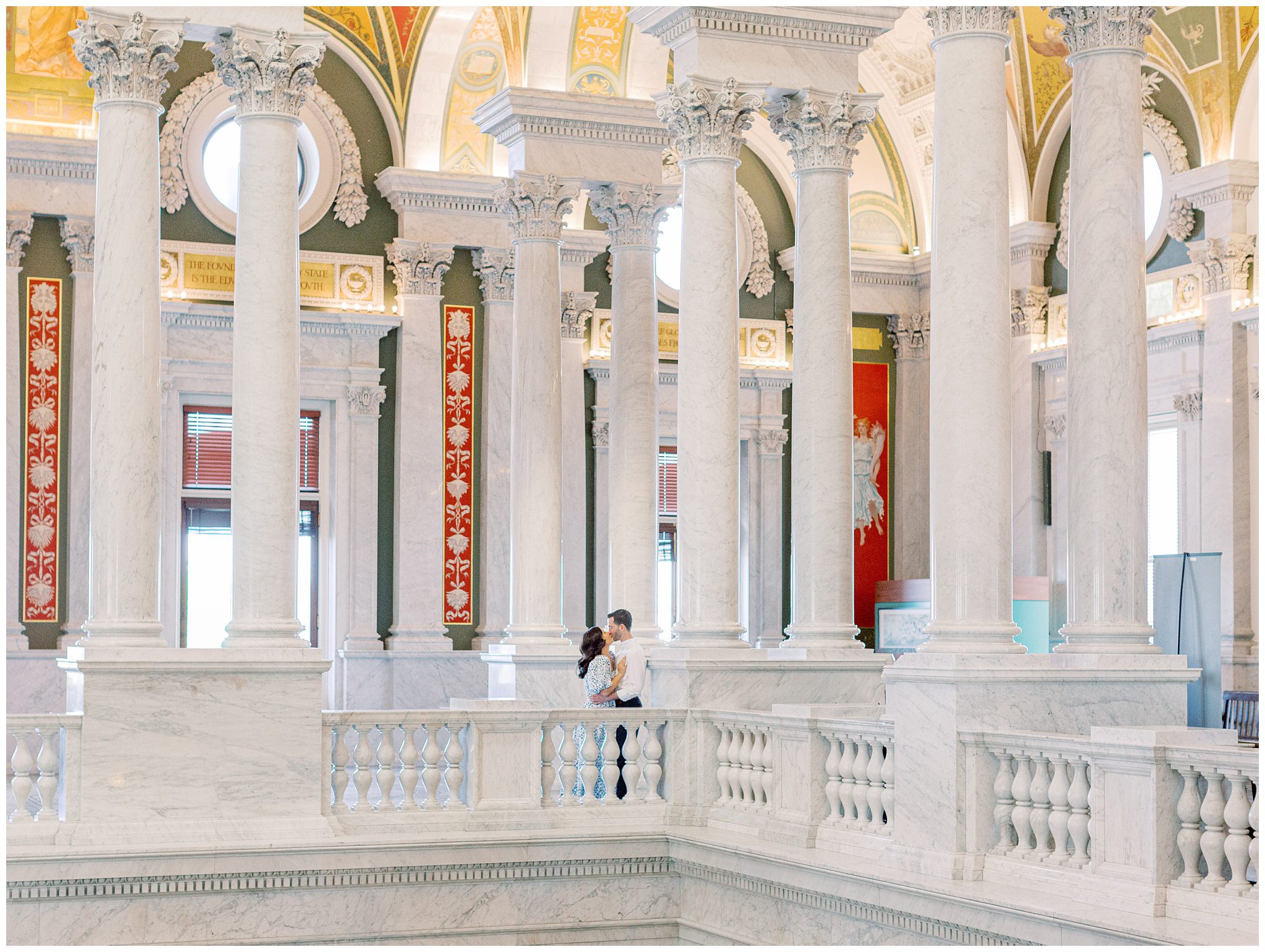 Couple kissing under marble columns at the Library of Congress