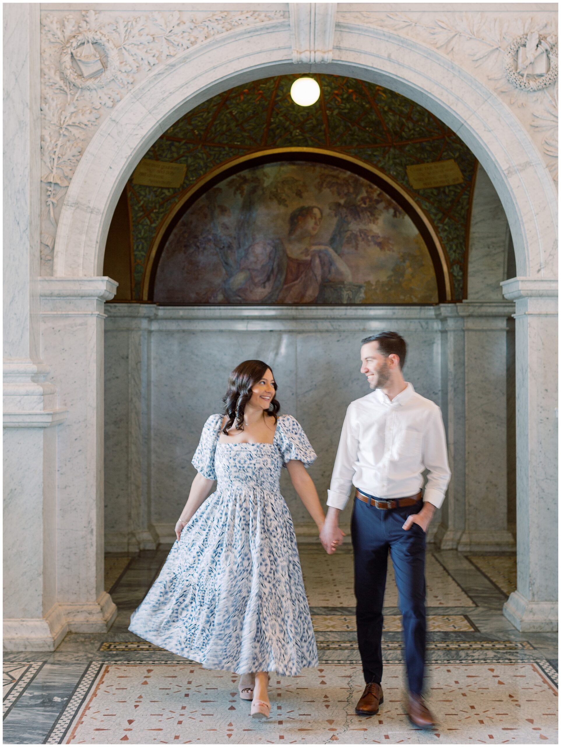 Couple captured in gentle motion during their Library of Congress engagement session in Washington, DC, with elegant architecture and timeless, old-world romance