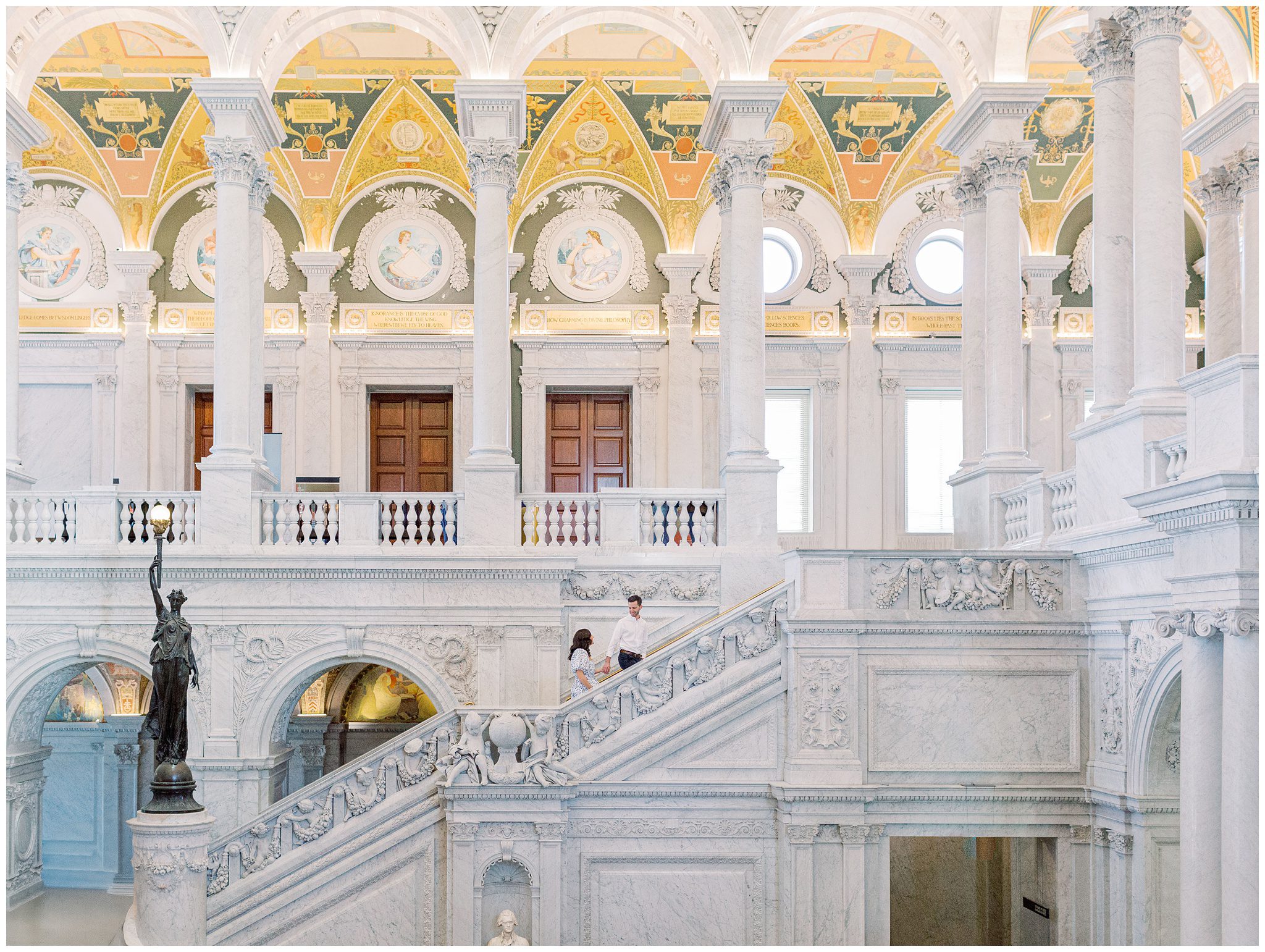 Couple walking up the marble stairs at the Library of Congress during their Washington DC engagement session