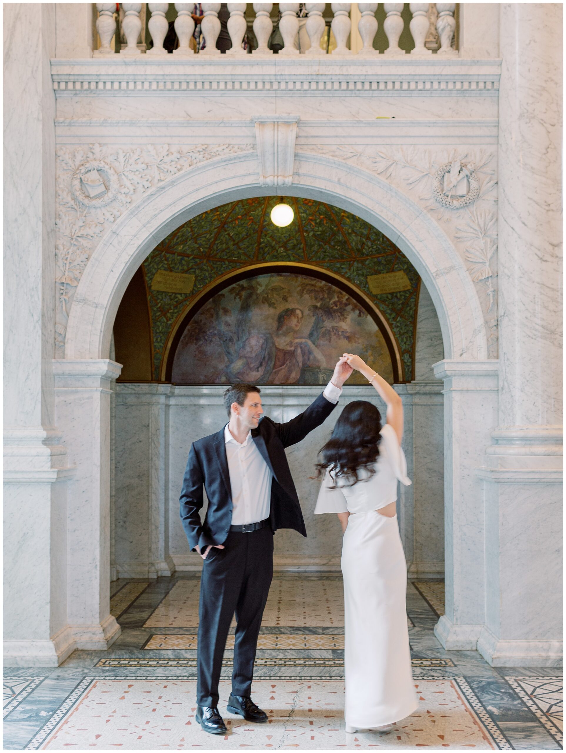 Mike twirling Jenny during their engagement session at the Library of Congress on the National Mall