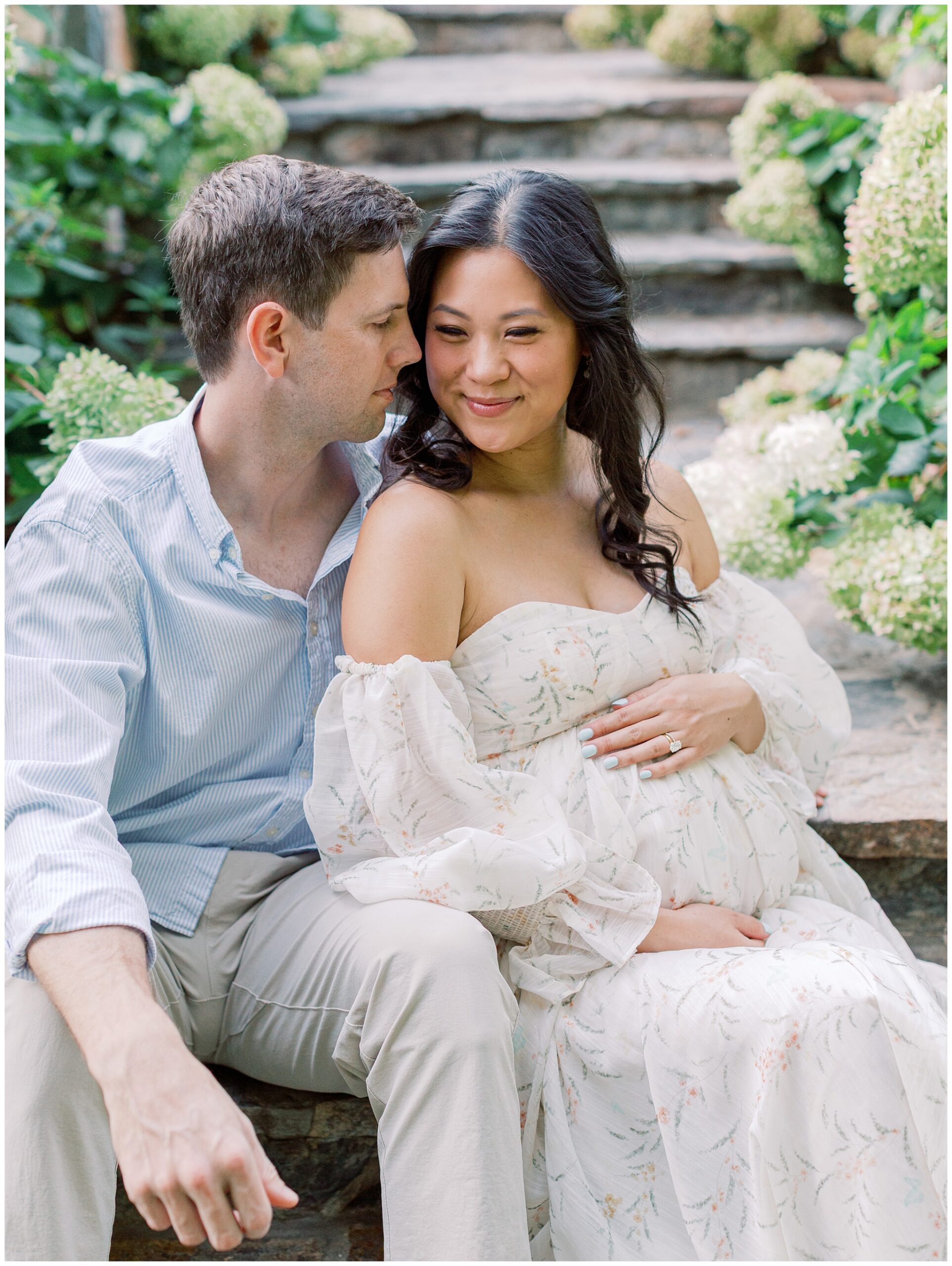 Hydrangea-lined staircase at Bluemont Vineyard with maternity couple