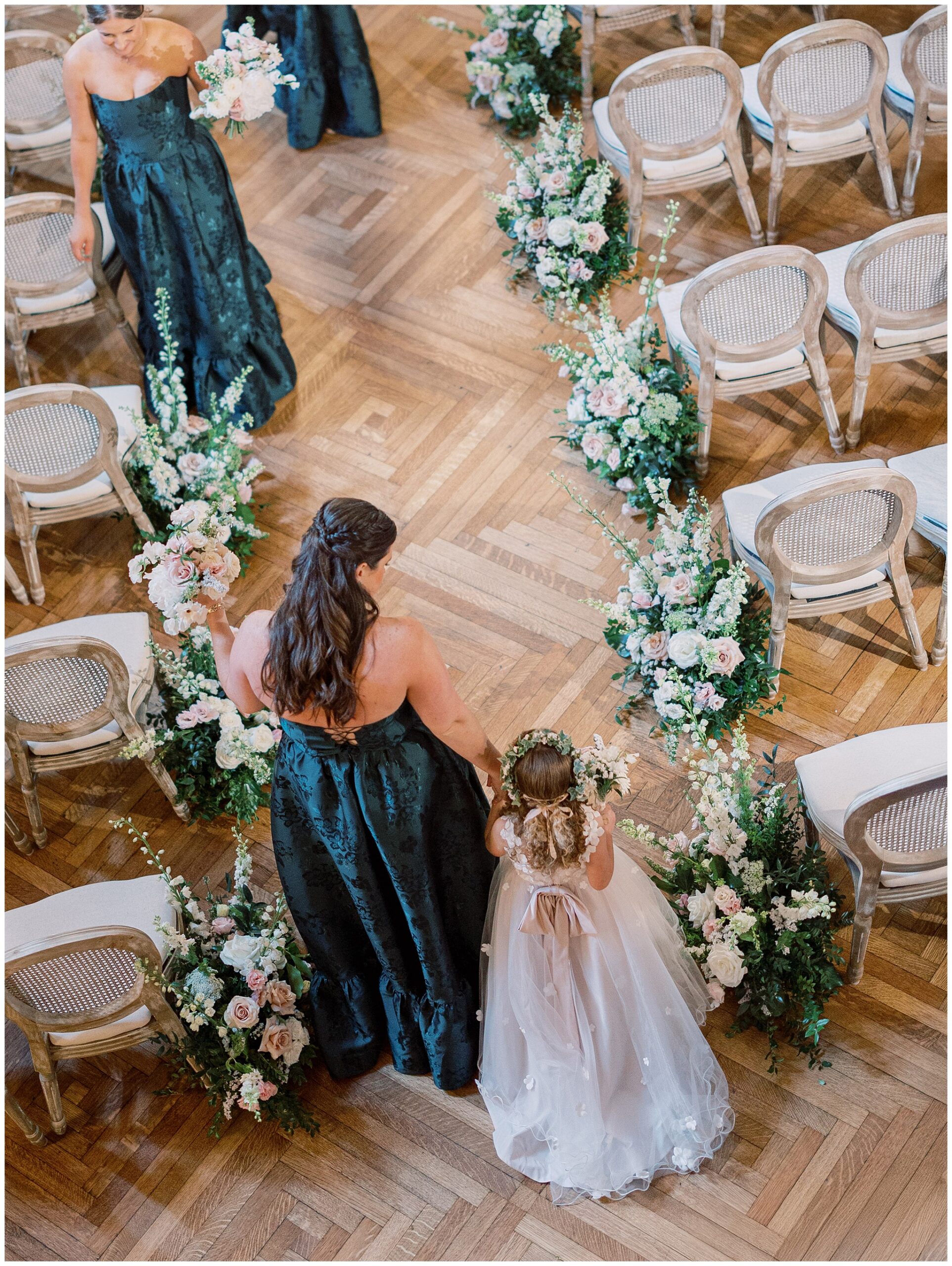 Bridesmaid and flower girl walking down the aisle in the Ballroom