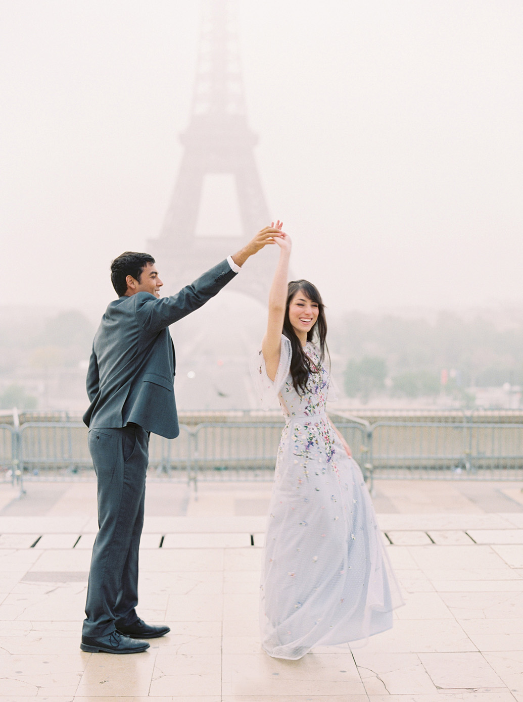 Portrait of Virginia wedding photographer Molly twirling with her husband in Paris