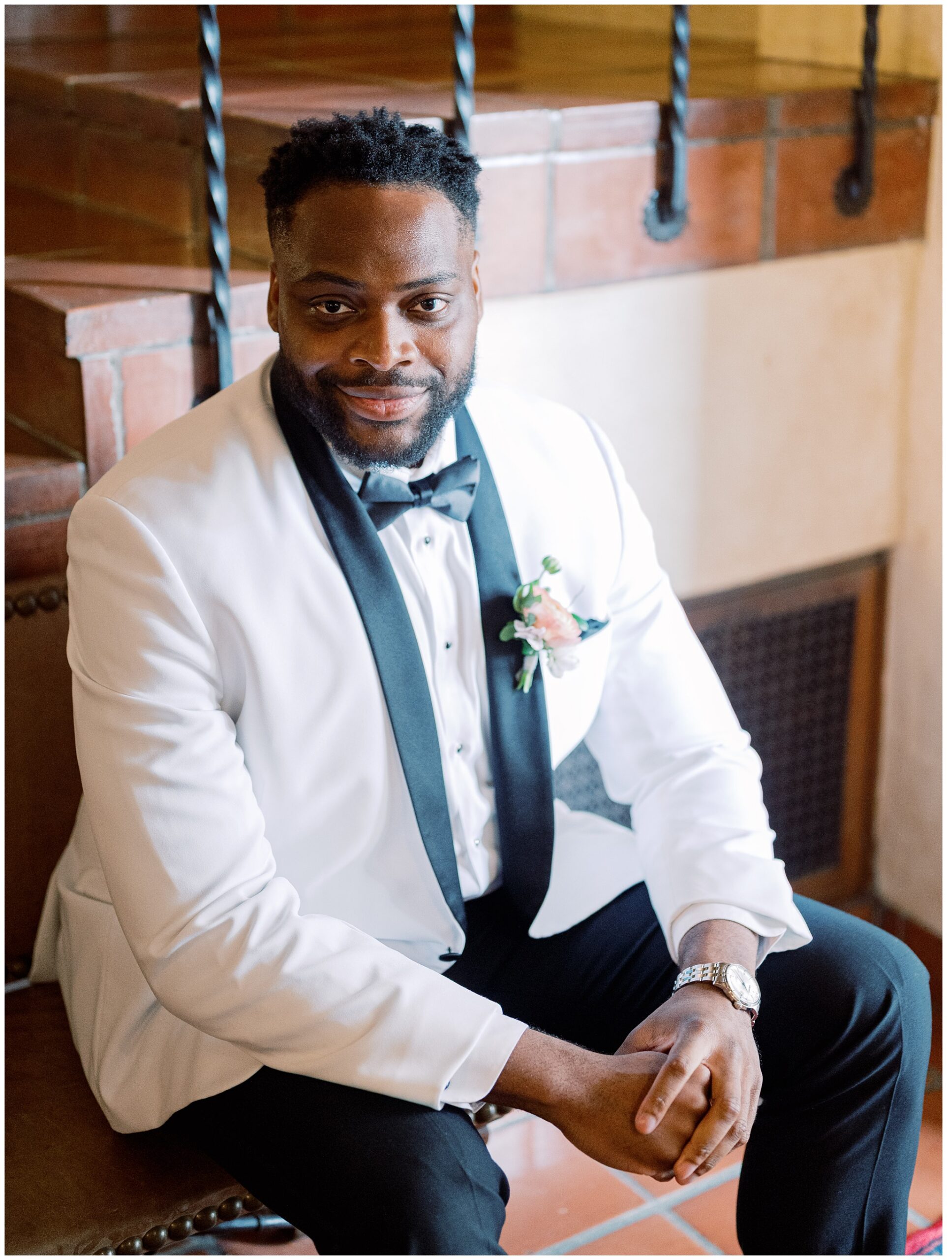Groom sitting outside the Library for a wedding portrait before the ceremony