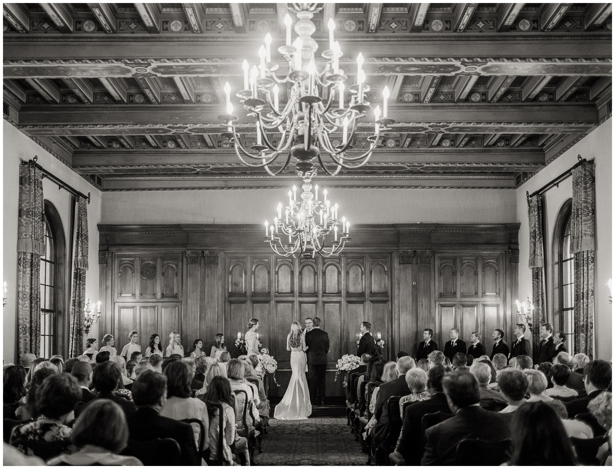 Wedding ceremony taking place in the Main Dining Room at the Caltech Athenaeum beneath the room’s historic painted ceilings