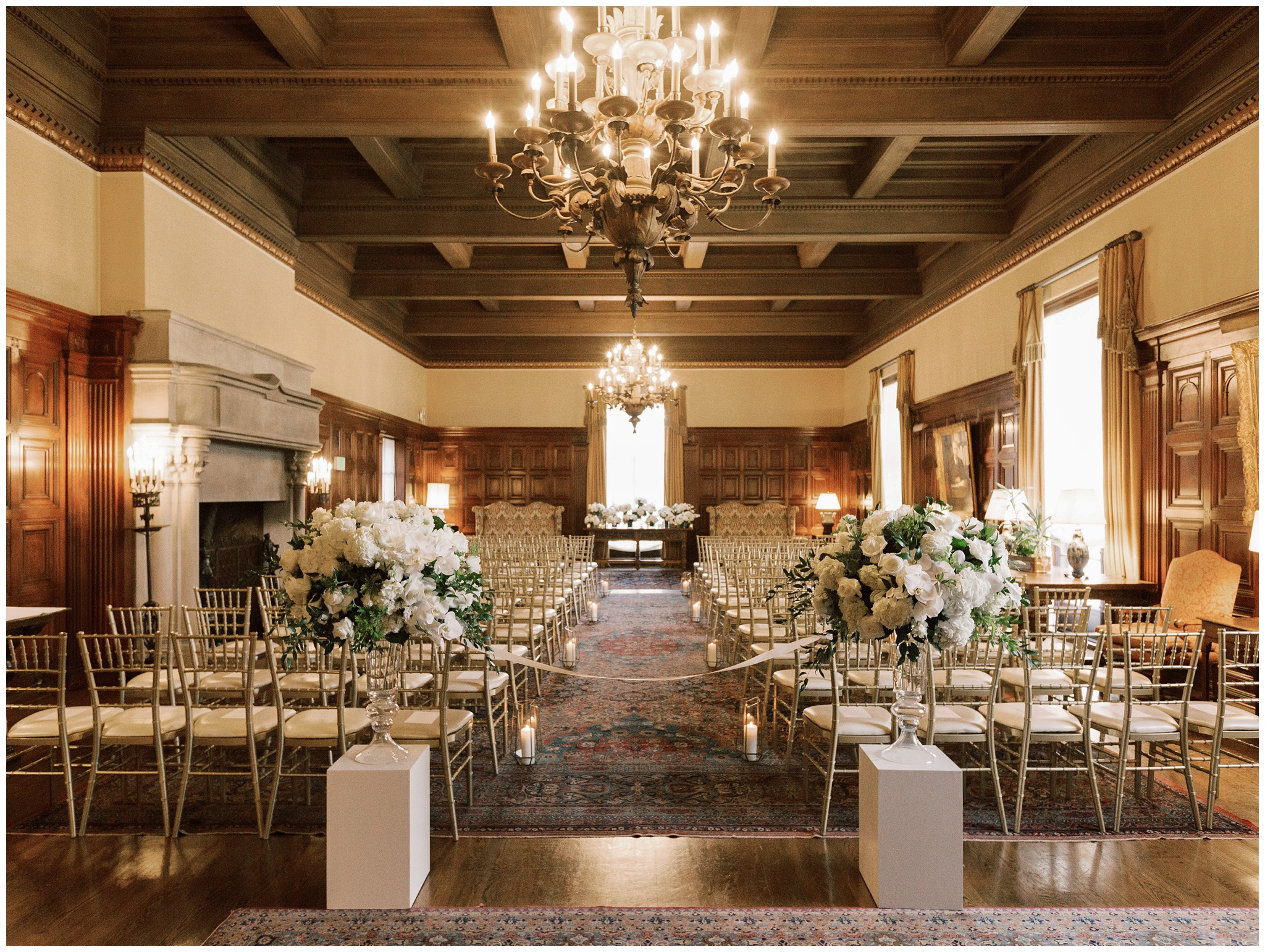 Wedding ceremony setup in the Main Lounge at the Caltech Athenaeum featuring elegant tables, floral arrangements, and the room’s wood-paneled interior
