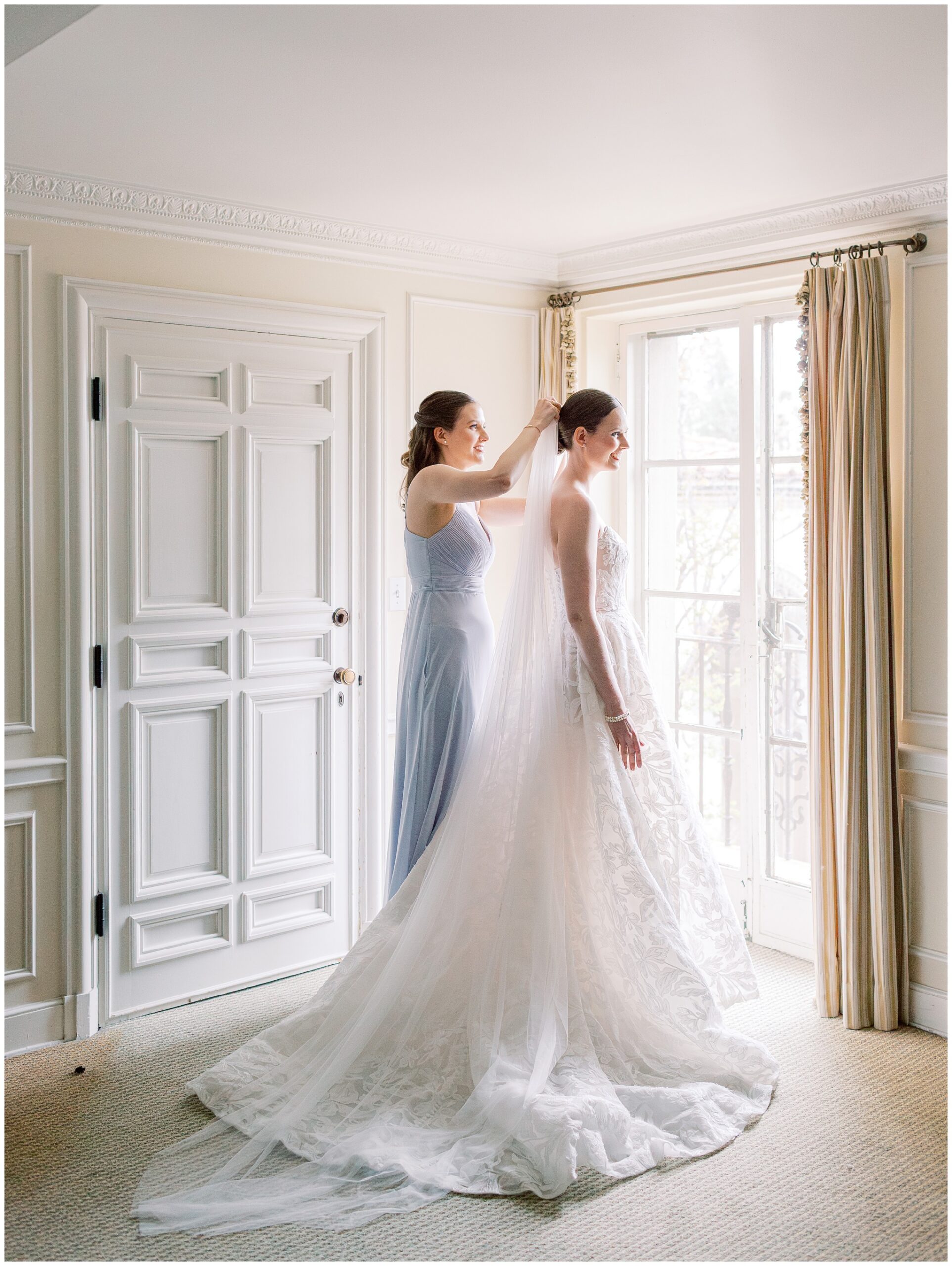 Bride getting dressed with her sister while preparing for her wedding day in the Mezzanine bridal suite