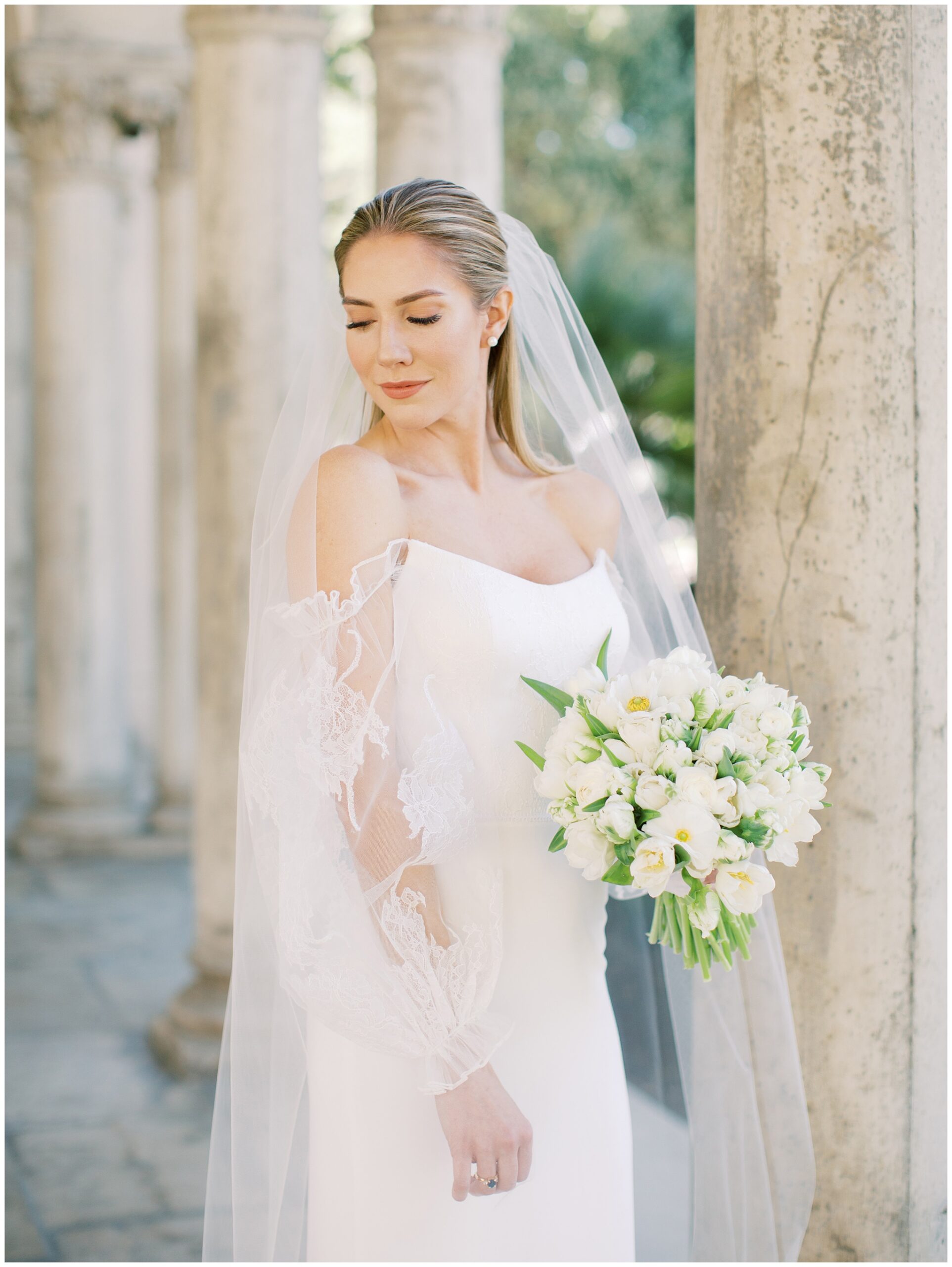 Bride’s close-up portrait beneath the columns during her wedding day
