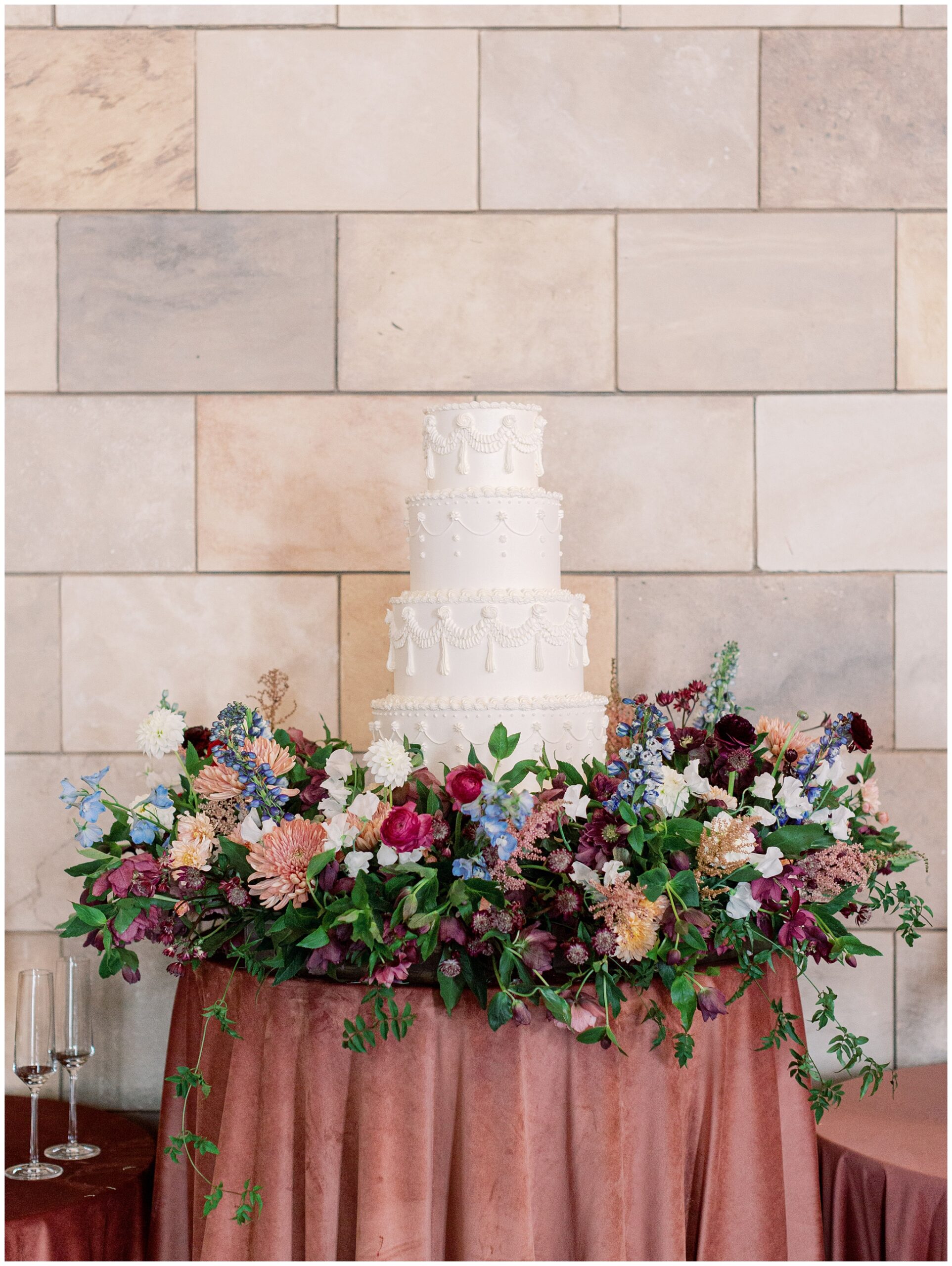 Elegant wedding cake surrounded by lush florals