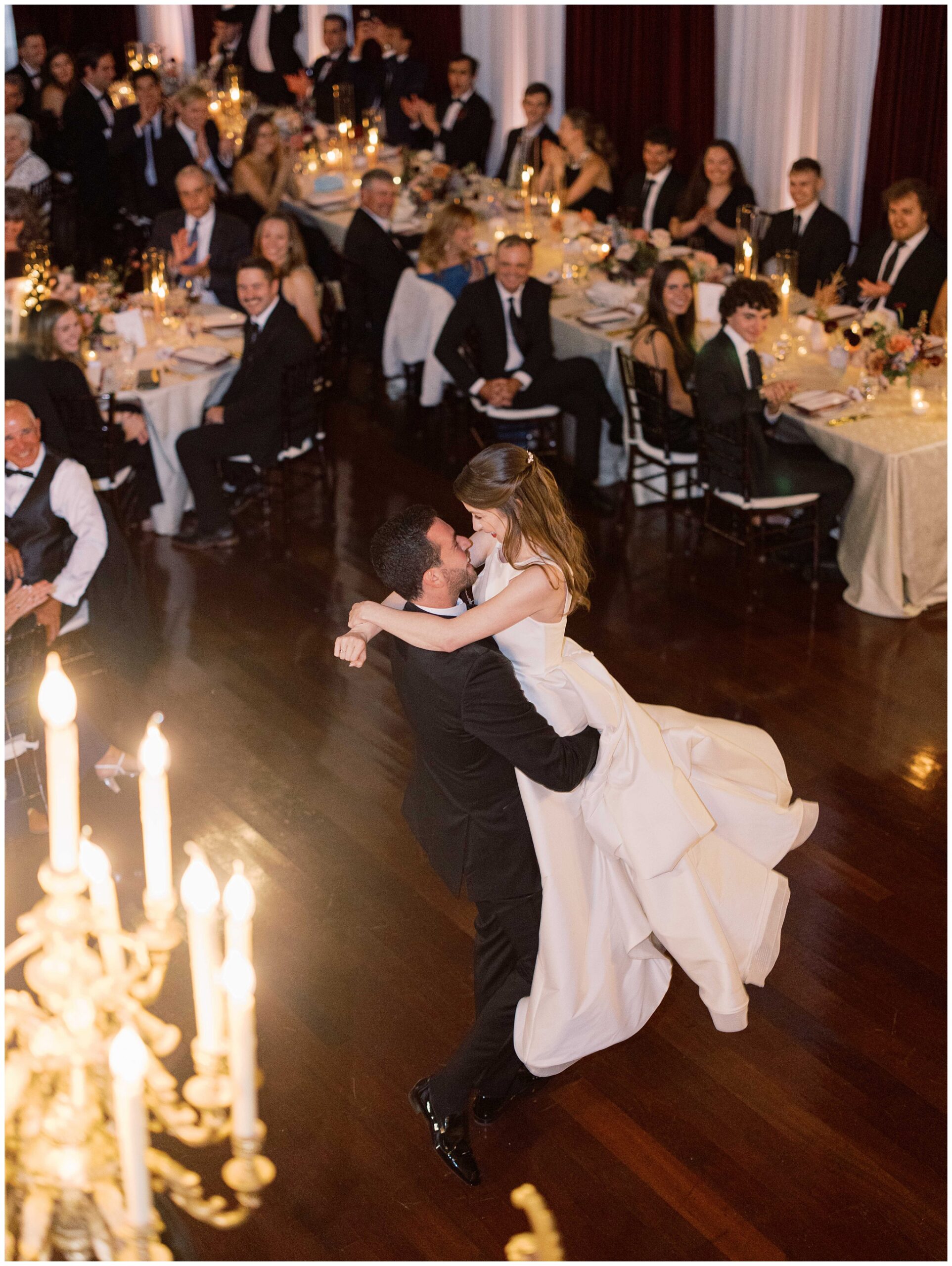 Groom lifting the bride during their first dance in the Ballroom