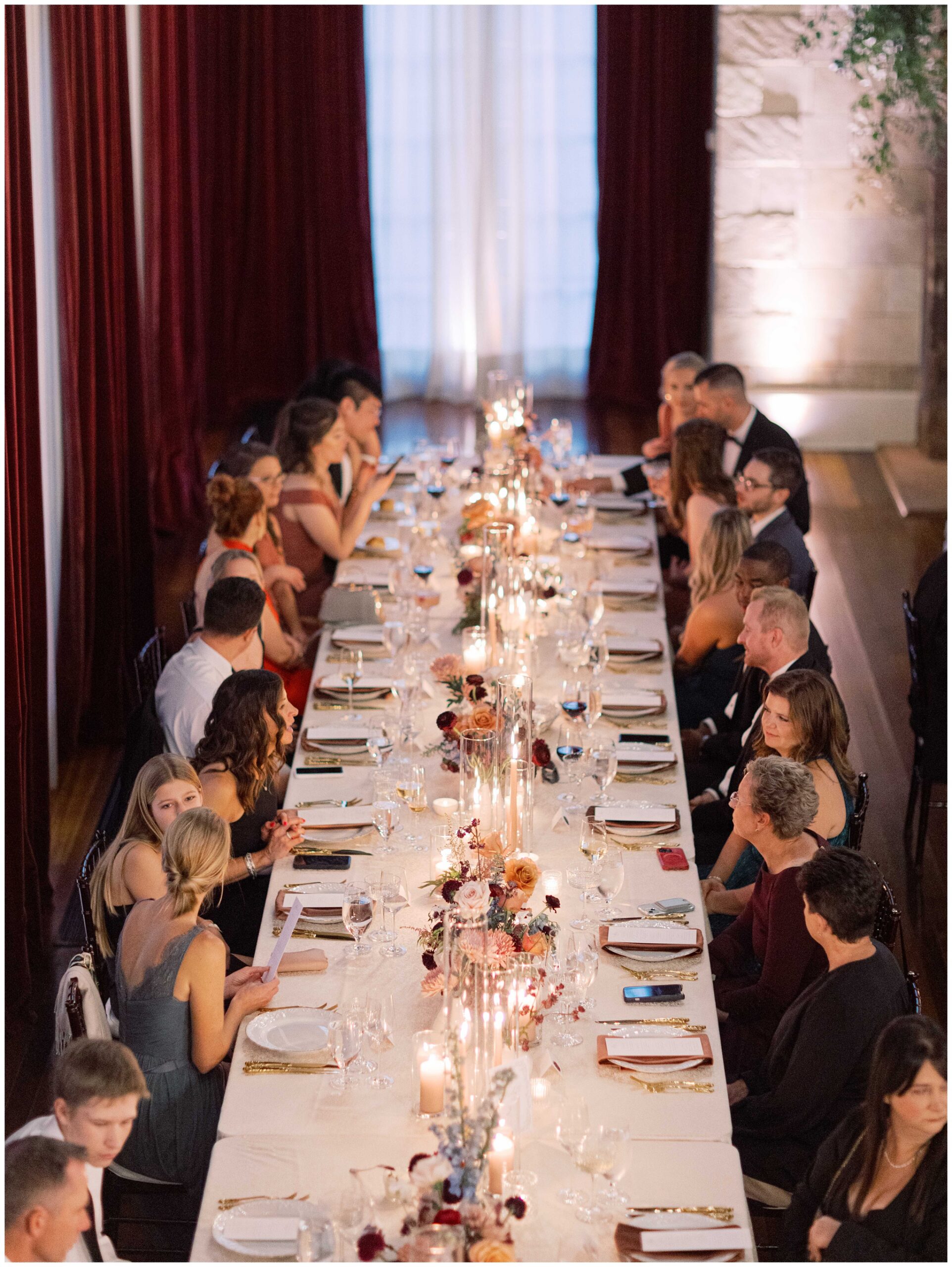 Wedding guests enjoying dinner at an elegantly decorated reception table