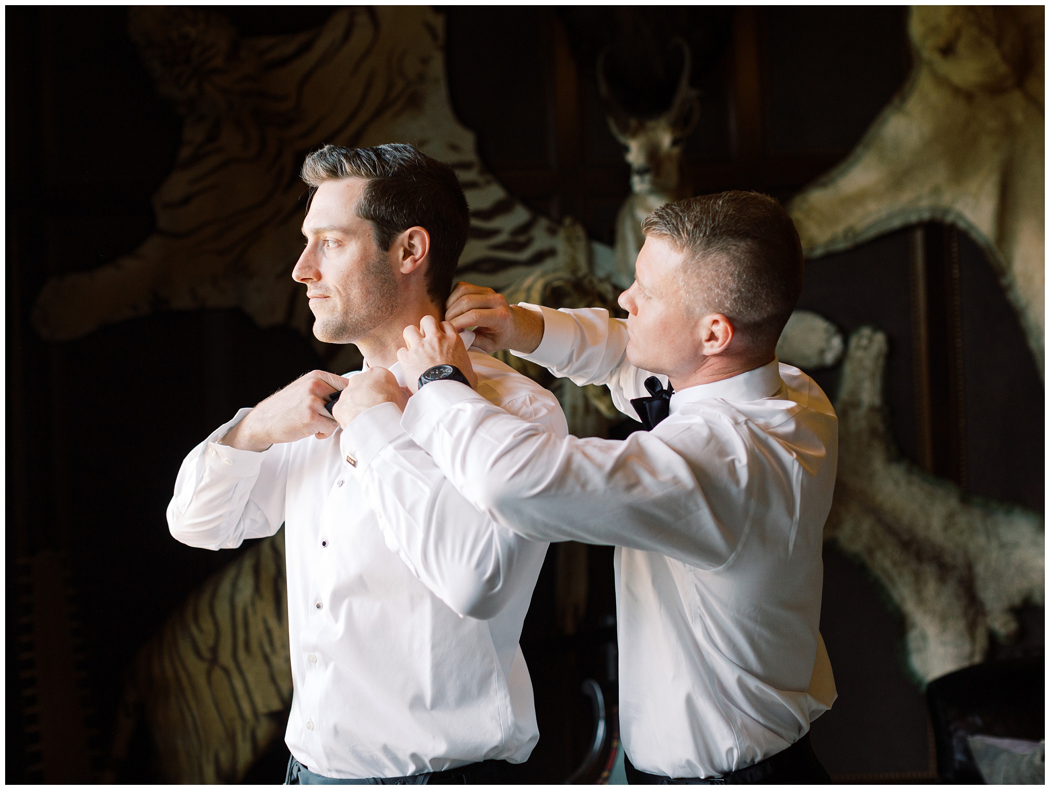 Groom getting ready with his groomsmen in the Billiards Room before the wedding