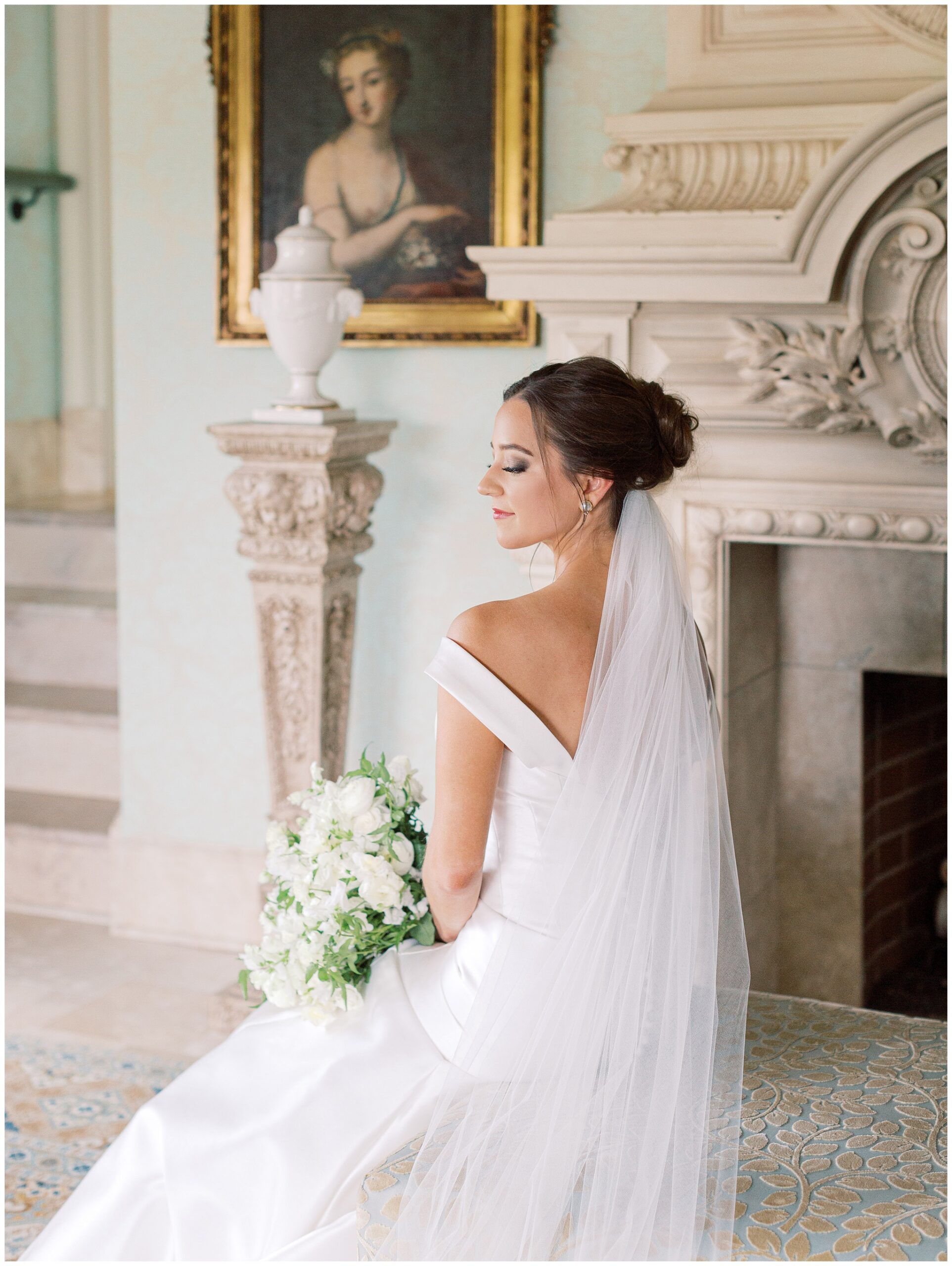 Bridal portrait of a bride sitting in the Parlor looking over her shoulder