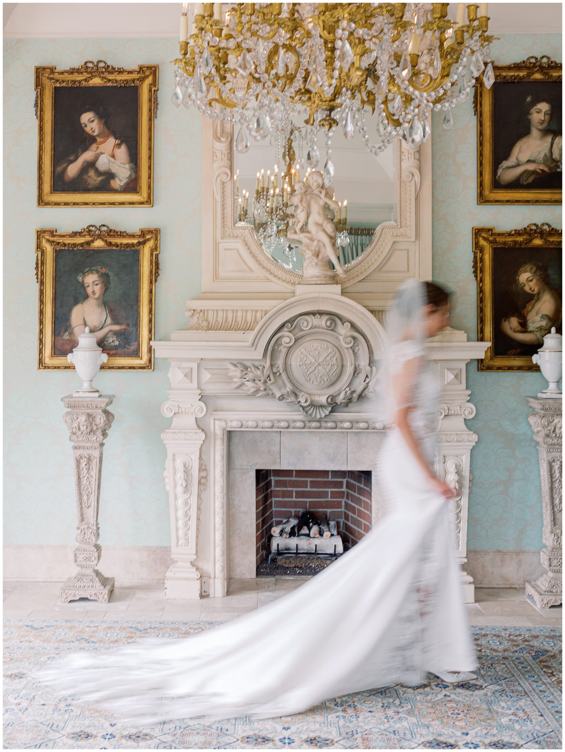Bride walking past an ornate fireplace with motion blur captured in her bridal portrait
