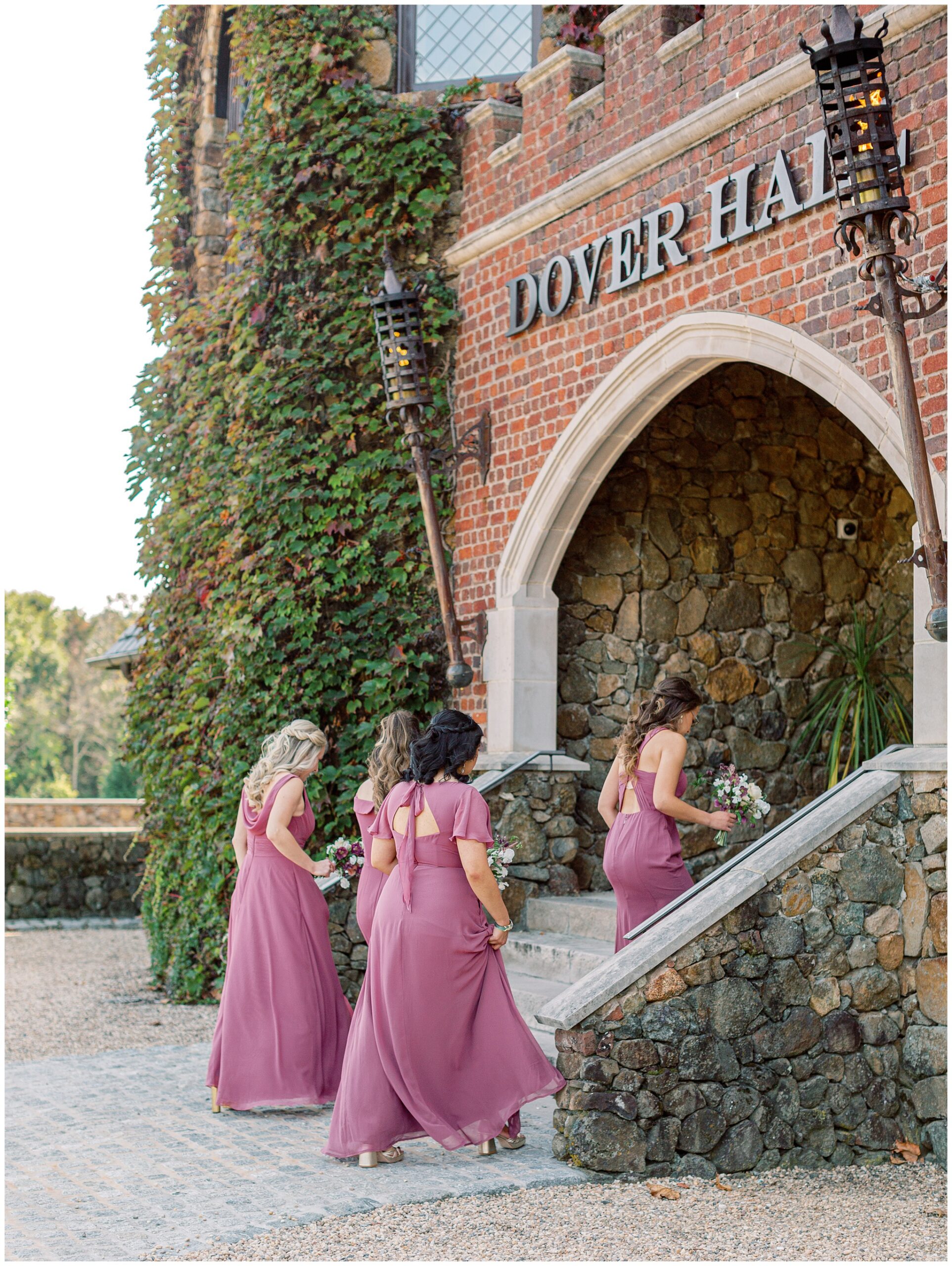 Bridesmaids walking up the front entrance steps of Dover Hall before the wedding ceremony