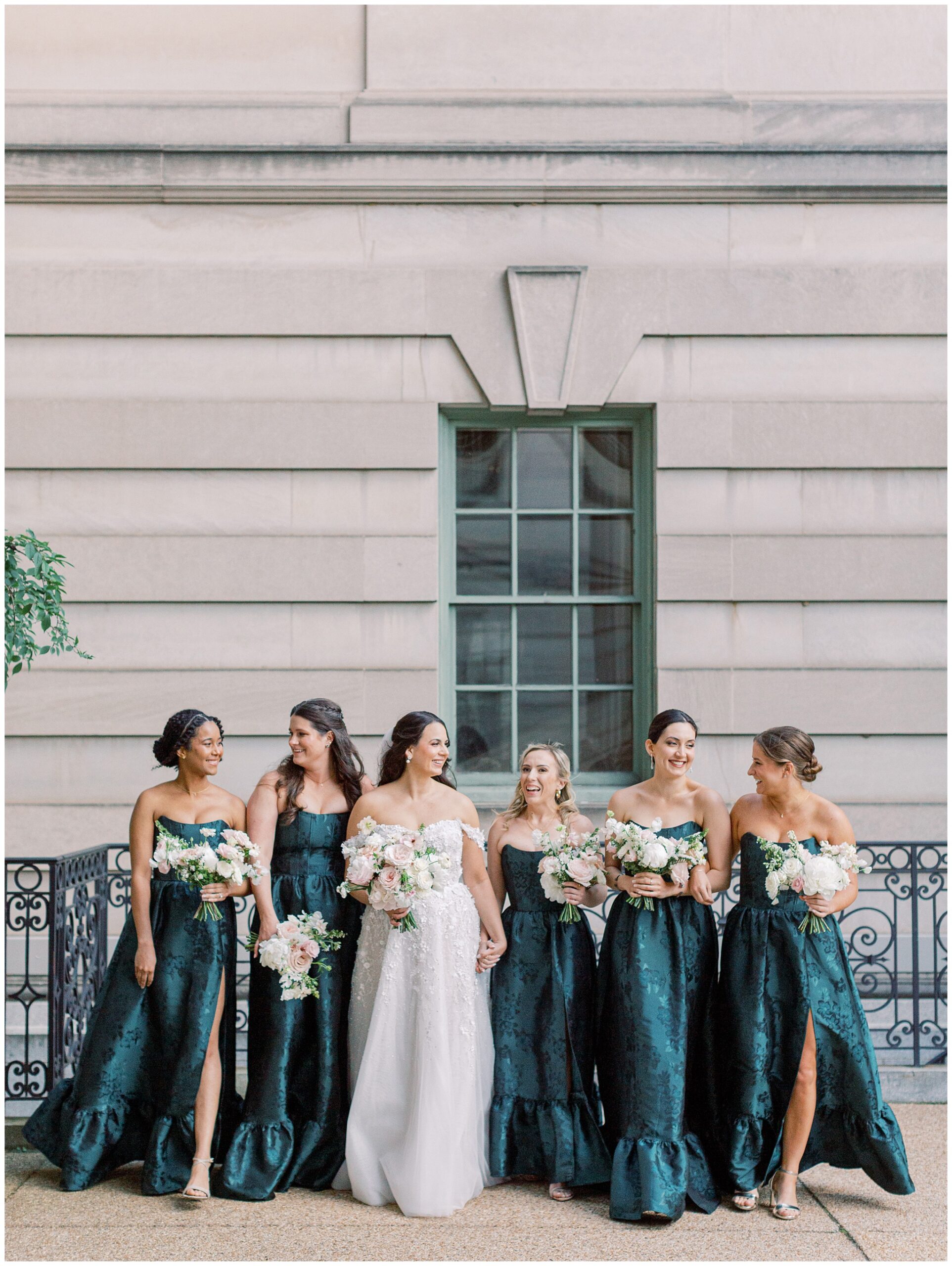 Bride and bridesmaids walking in front of Anderson House