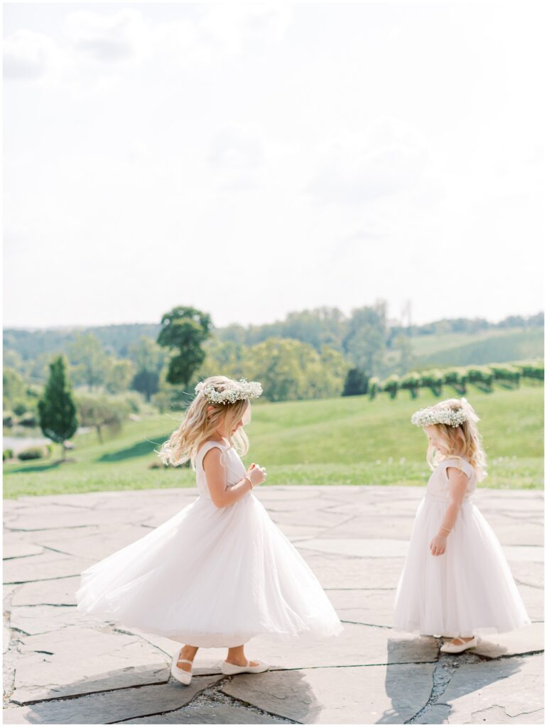 Flower girls twirling at the Stone Circle at Stone Tower Winery overlooking the vines