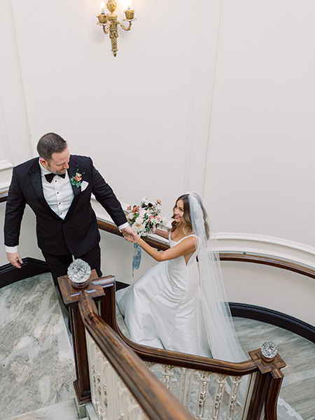 wedding couple walking up staircase at dar wedding in washington dc